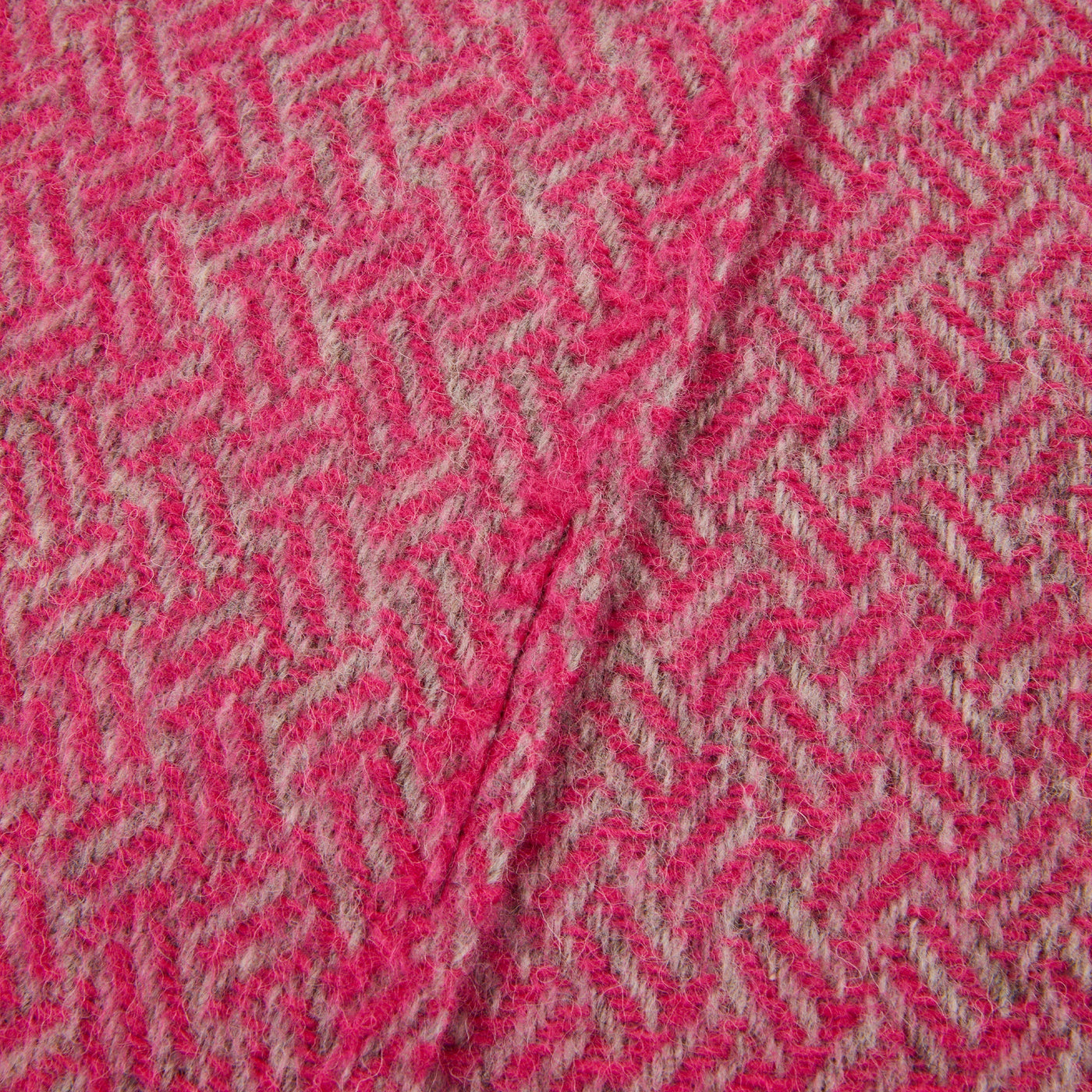 Close-up of Lanerossi Mata Mata throw in raspberry and oat herringbone wool weave.