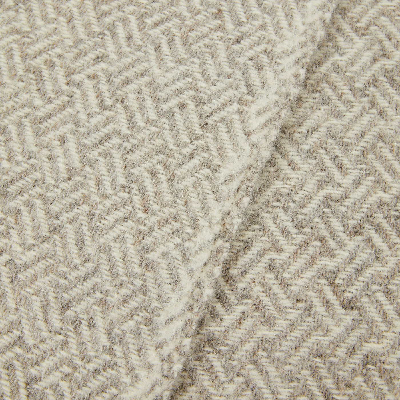 Close-up of Lanerossi Mata Mata throw showing ivory and natural herringbone weave texture.