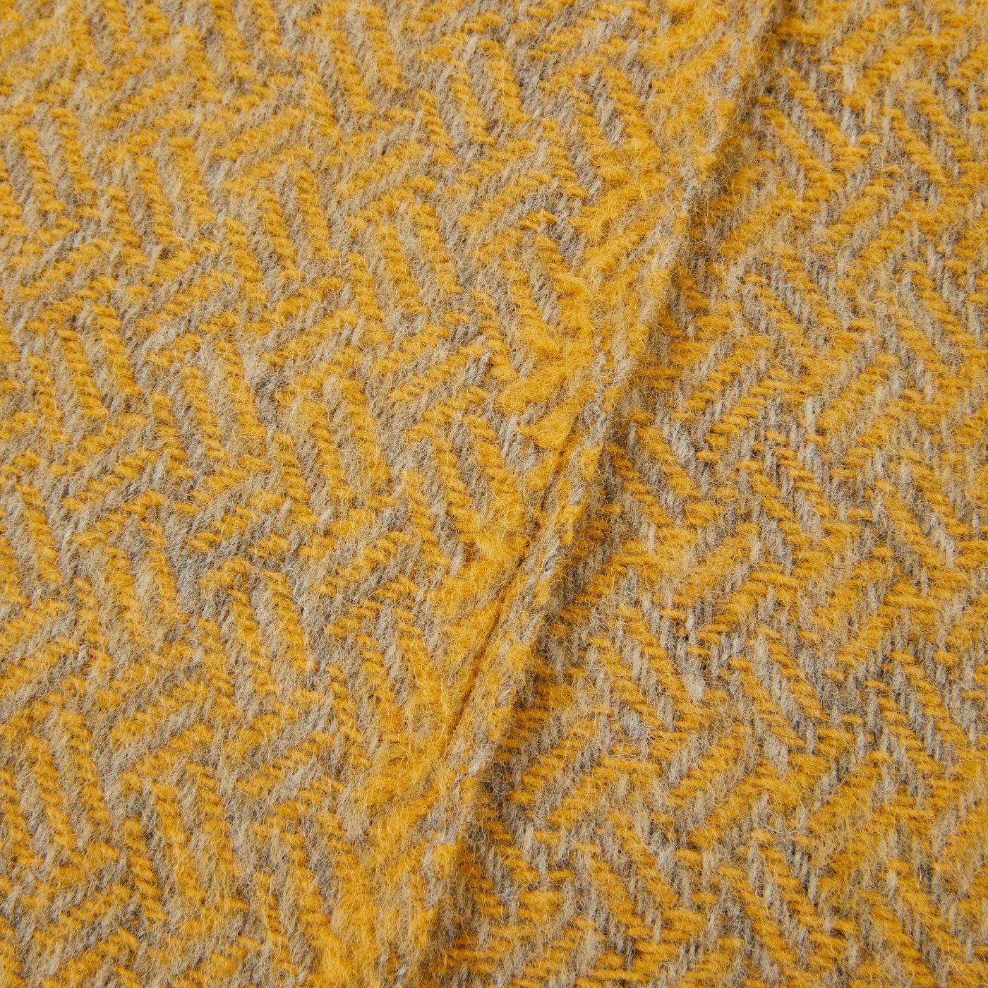 Close-up of Lanerossi Mata Mata throw's saffron and grey herringbone wool weave texture.