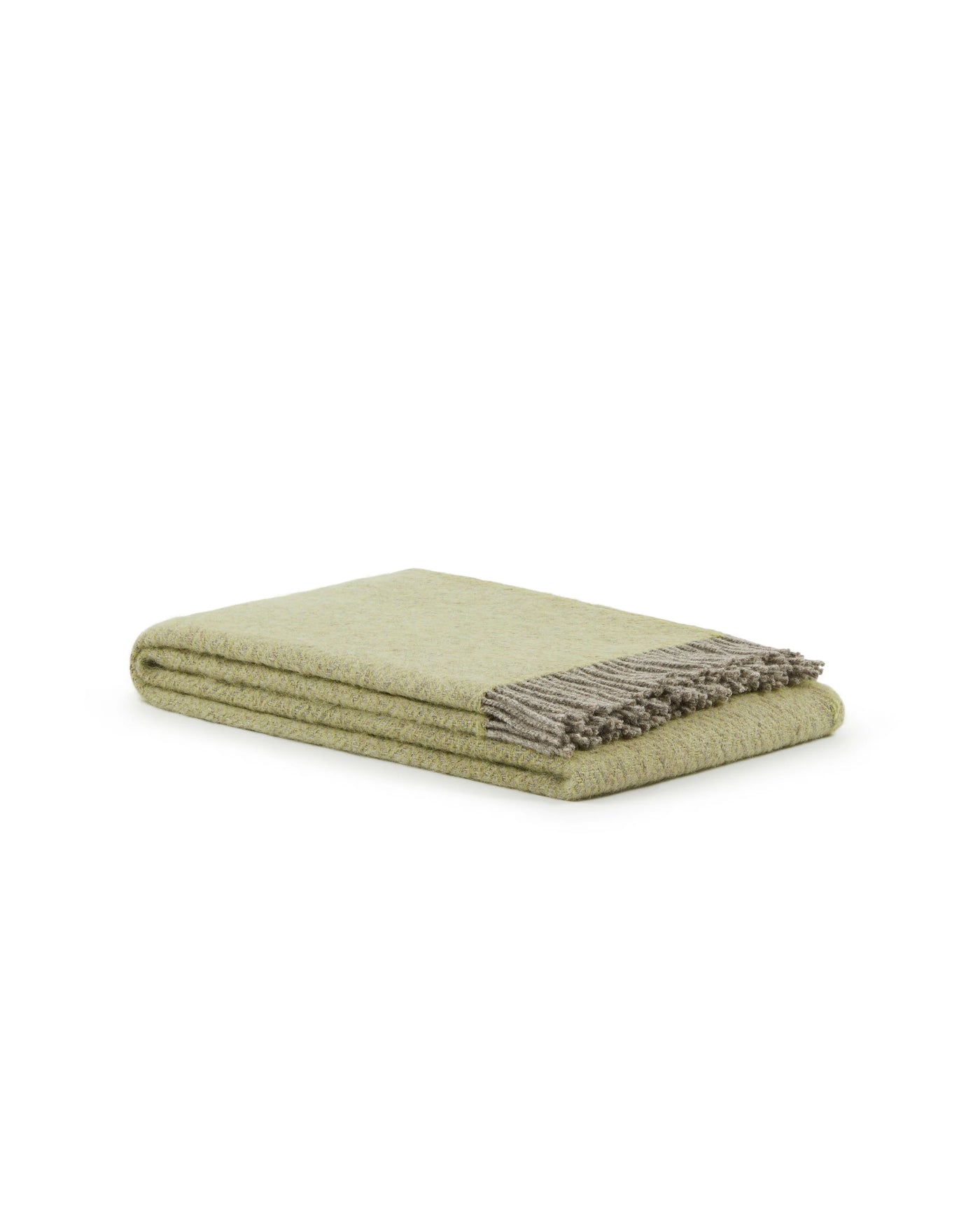 Folded sage green wool throw with contrast taupe fringe detail, angled view.