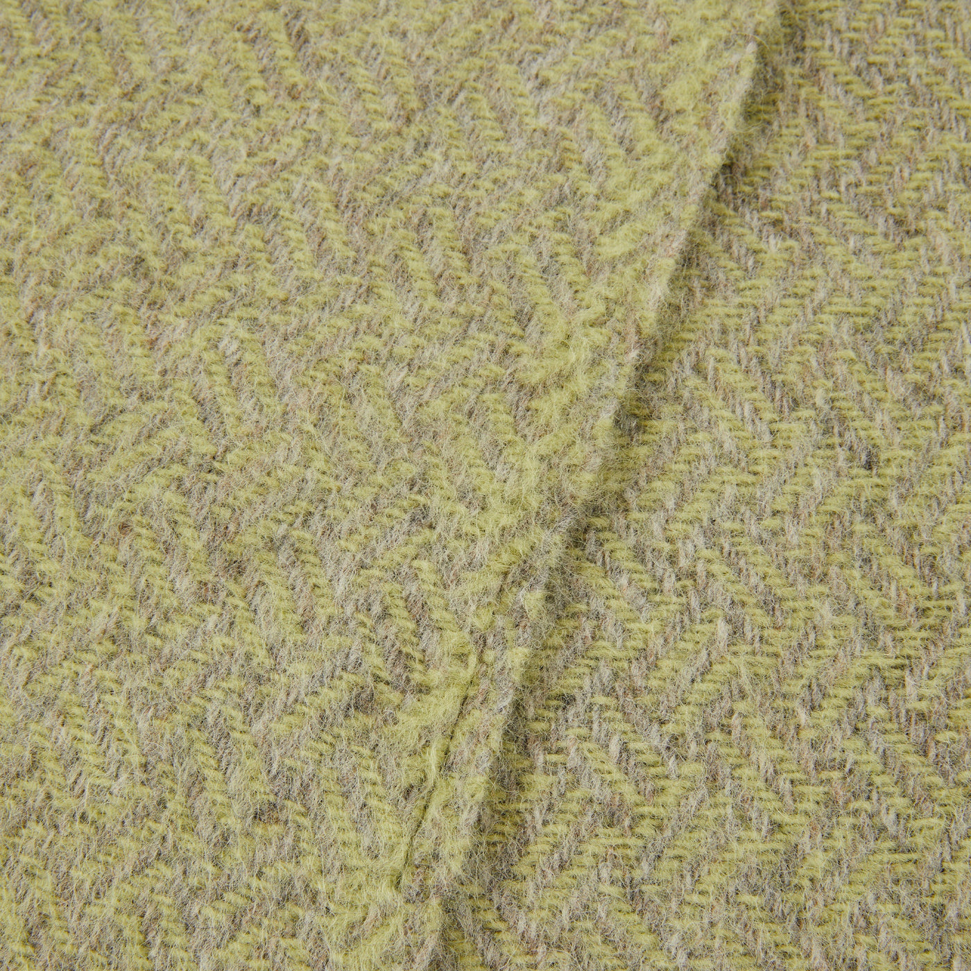 Close-up of Lanerossi Mata Mata throw's chartreuse and grey herringbone weave texture.