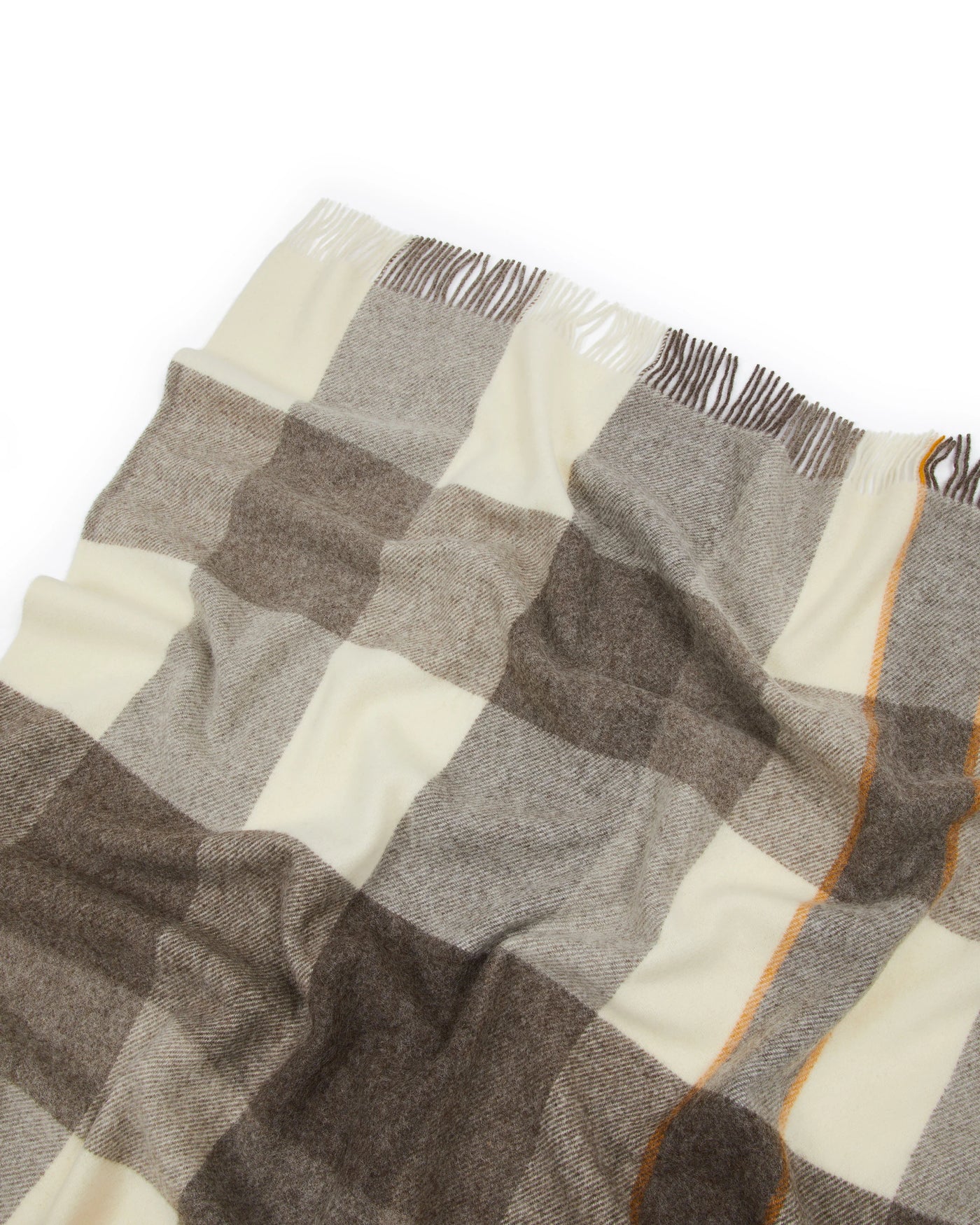 Close-up of Lanerossi Nelson throw fringe edge, ivory and taupe check with amber trim detail.