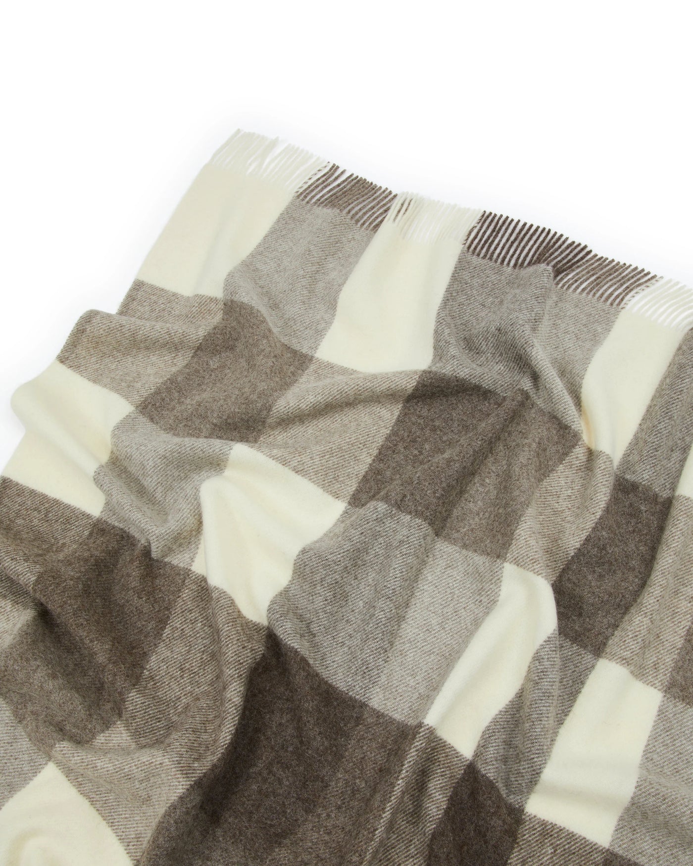 Close-up of Lanerossi Nelson throw fringe and taupe check pattern in ivory and warm brown.