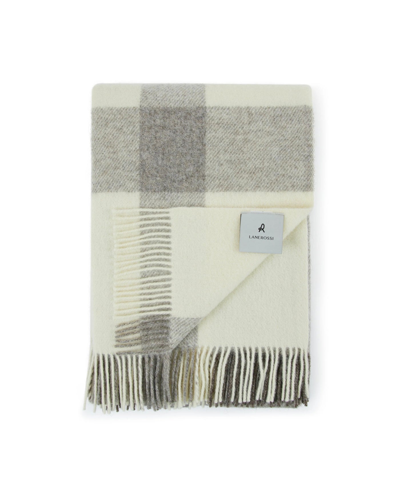 Close-up of folded Lanerossi Nelson throw in ivory and grey check with knotted fringe trim.