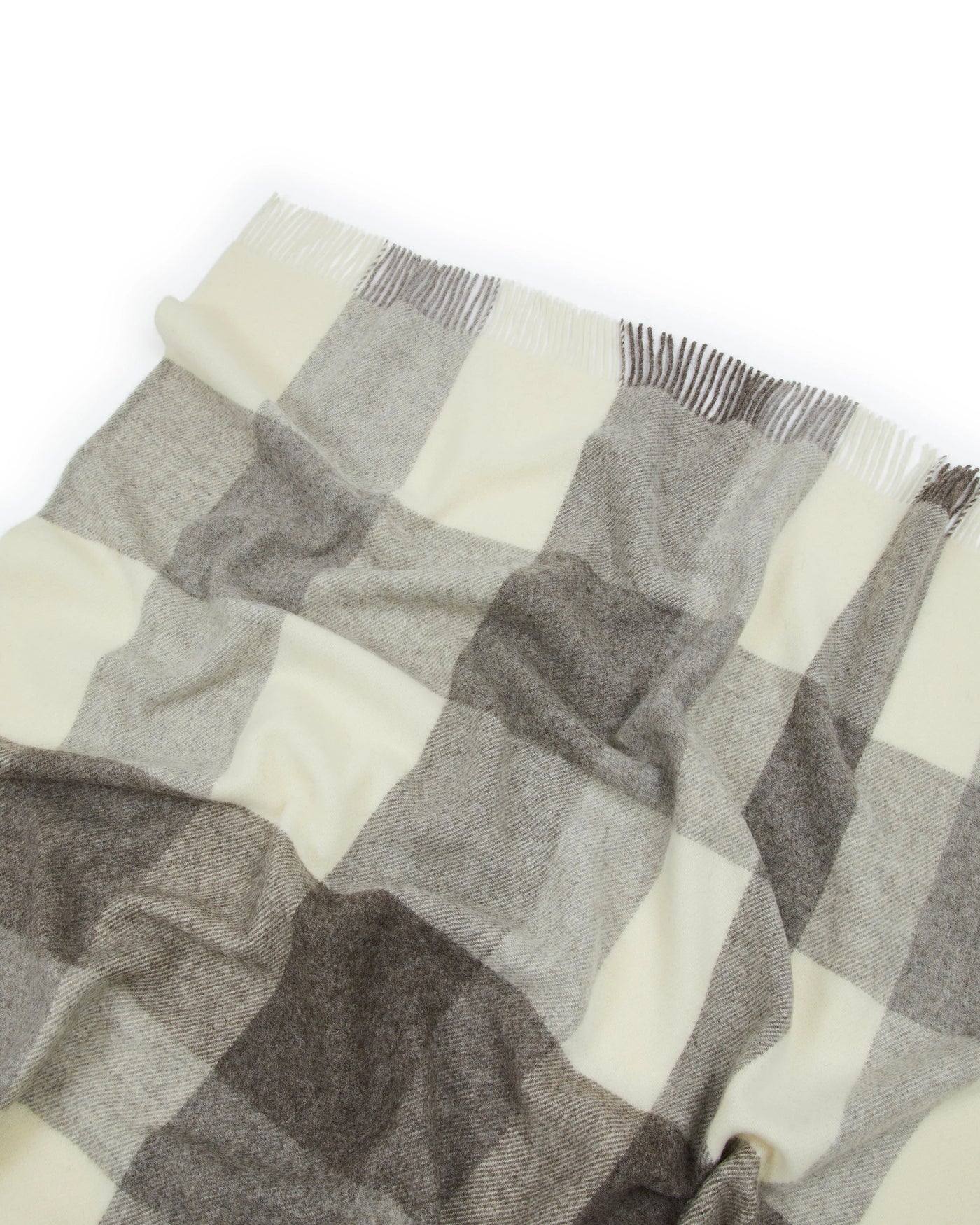 Close-up of Lanerossi Nelson throw fringe edge, ivory and grey block check wool weave.