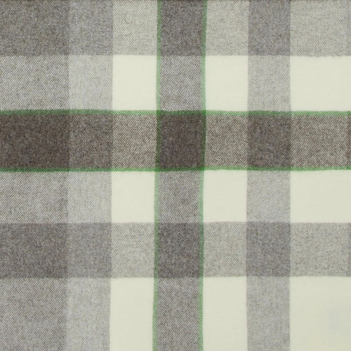 Close-up of Lanerossi Nelson throw in ivory and grey plaid with green accent stripe detail.