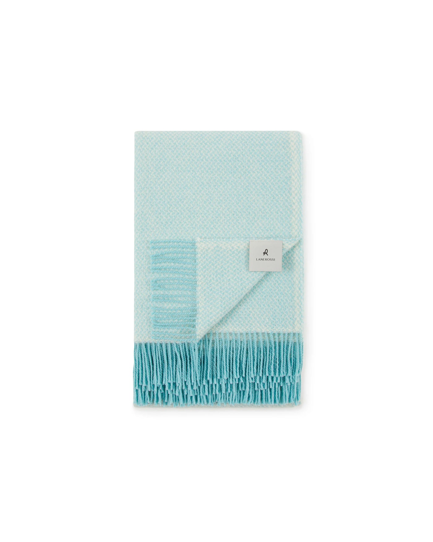 Corner fold detail showing aqua fringe and woven texture of Lanerossi Northland throw.