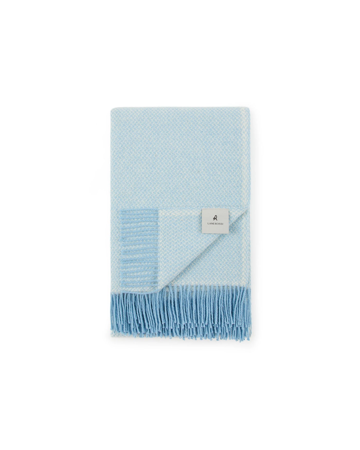 Folded sky blue Lanerossi Northland throw showing fringe trim and woven diamond texture detail.