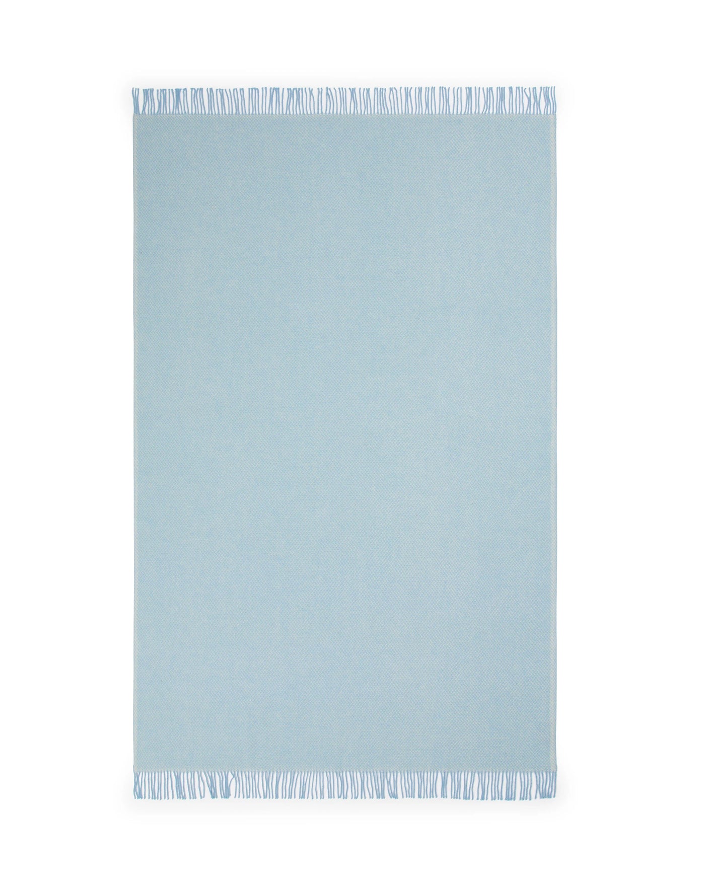 Pale blue Lanerossi Northland throw with short white fringe trim along both short edges.