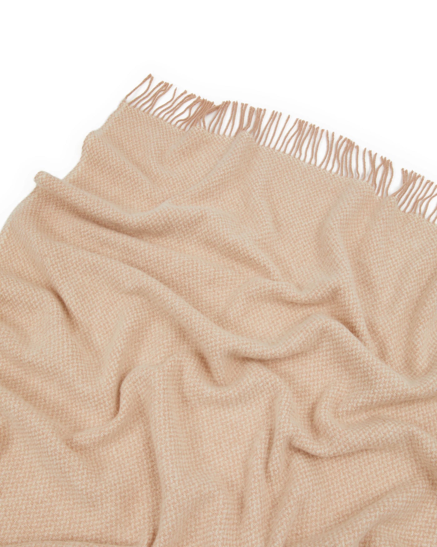 Close-up of Lanerossi Northland throw in blush, showing woven texture and fringe trim.