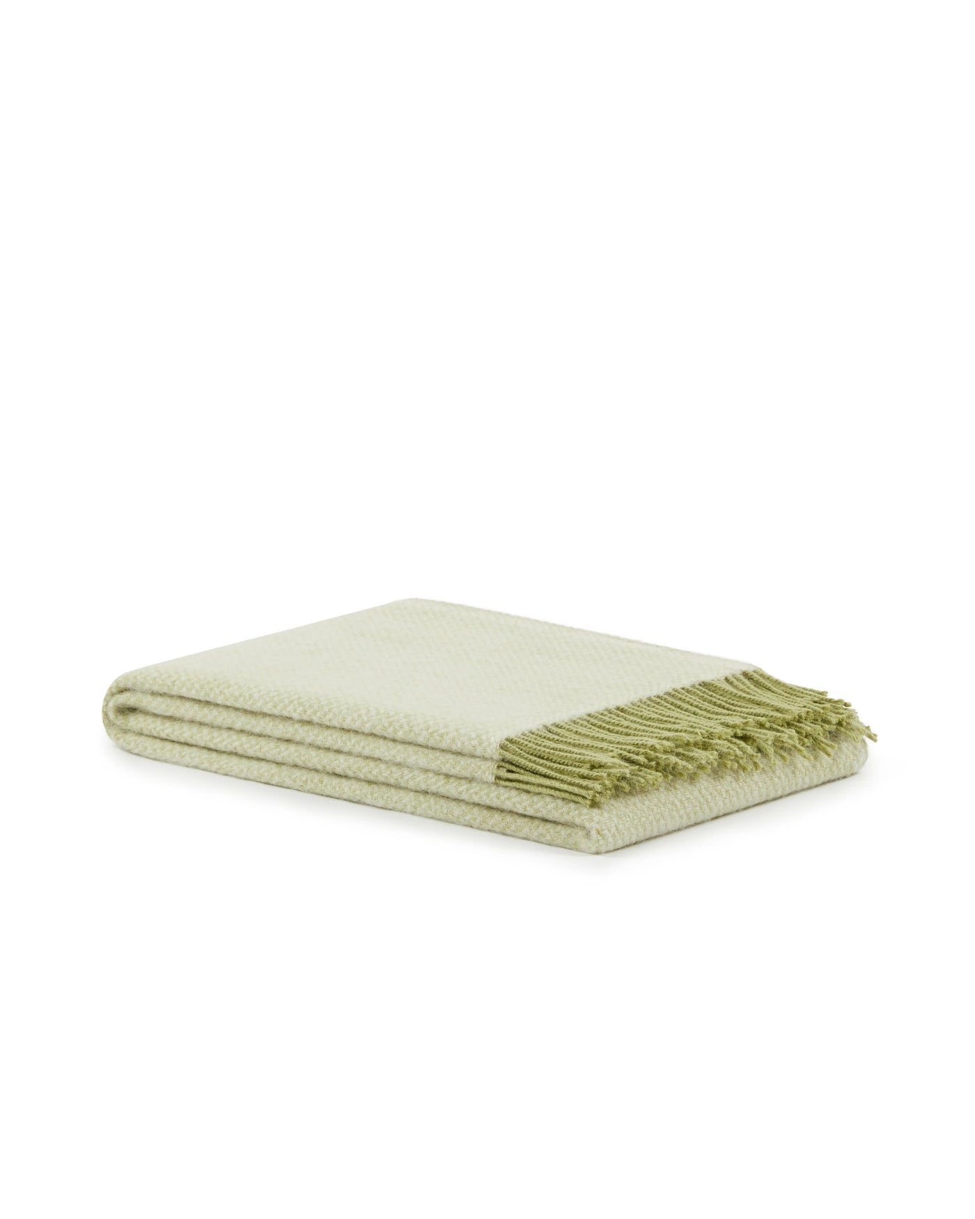 Folded sage green throw with fringe trim, shown against white background.