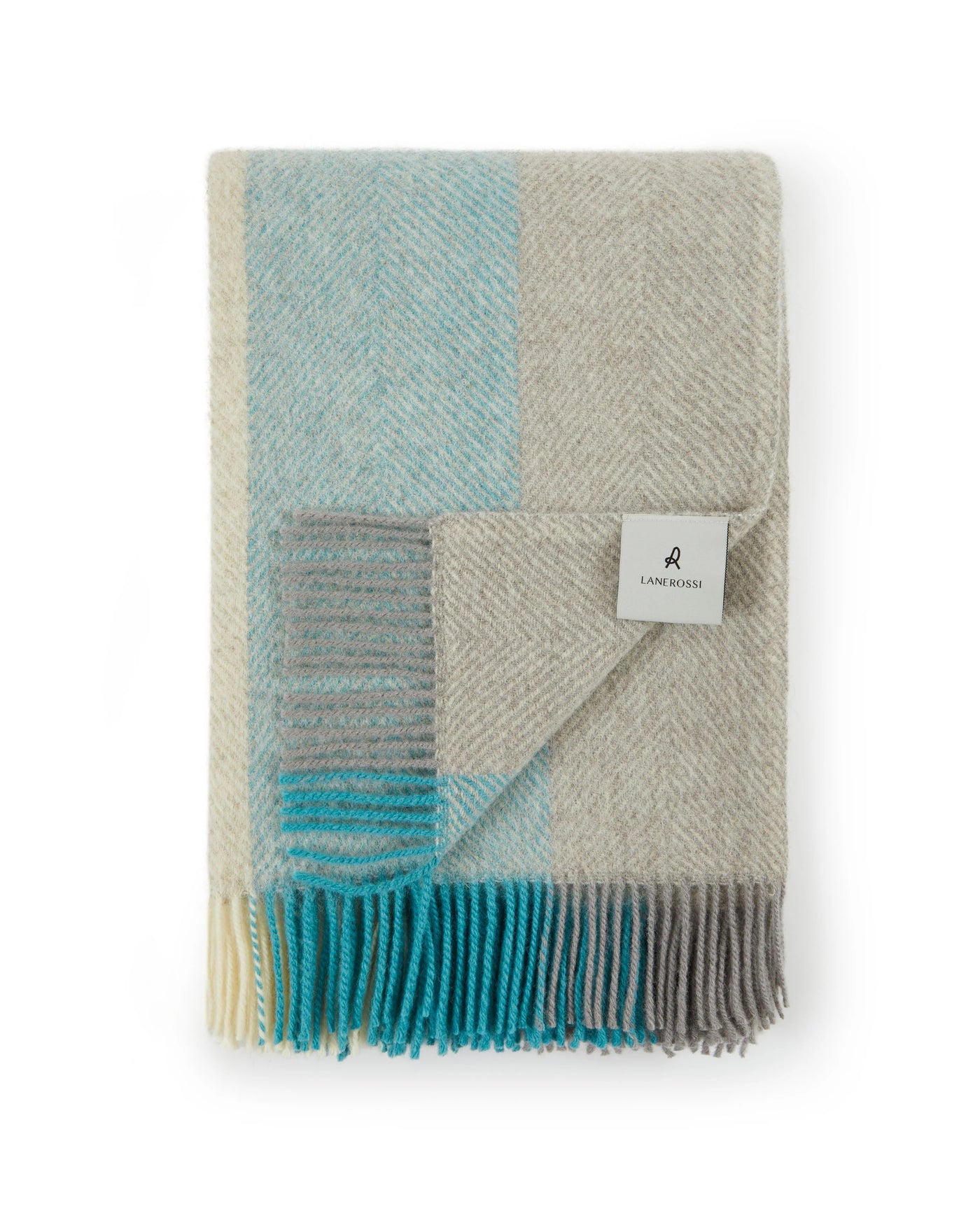 Close-up of folded Lanerossi Opua throw in aqua, grey, and ivory colorblock with fringe hem.