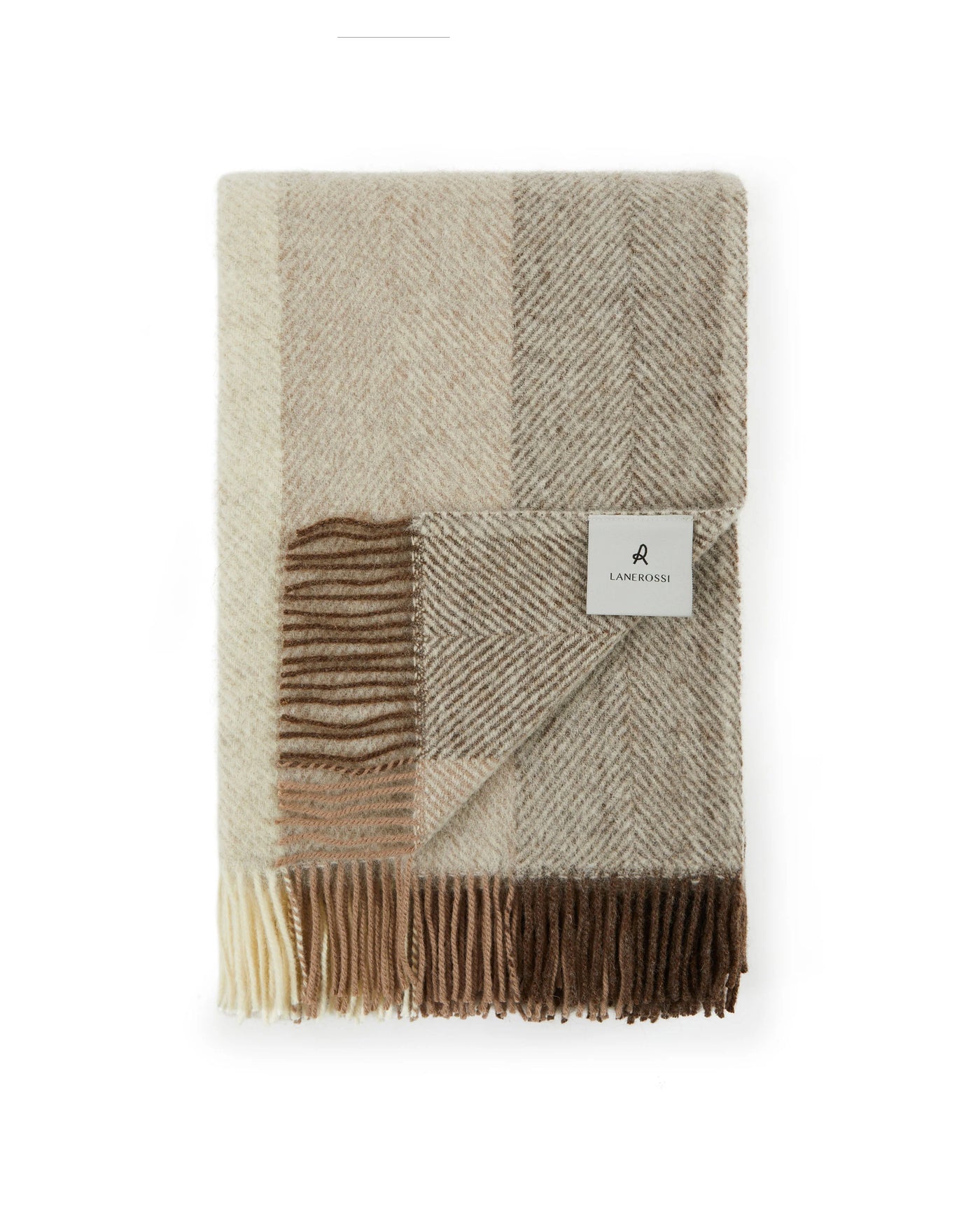 Lanerossi Opua throw folded, showing patchwork herringbone weave in ivory and camel tones with fringe trim.