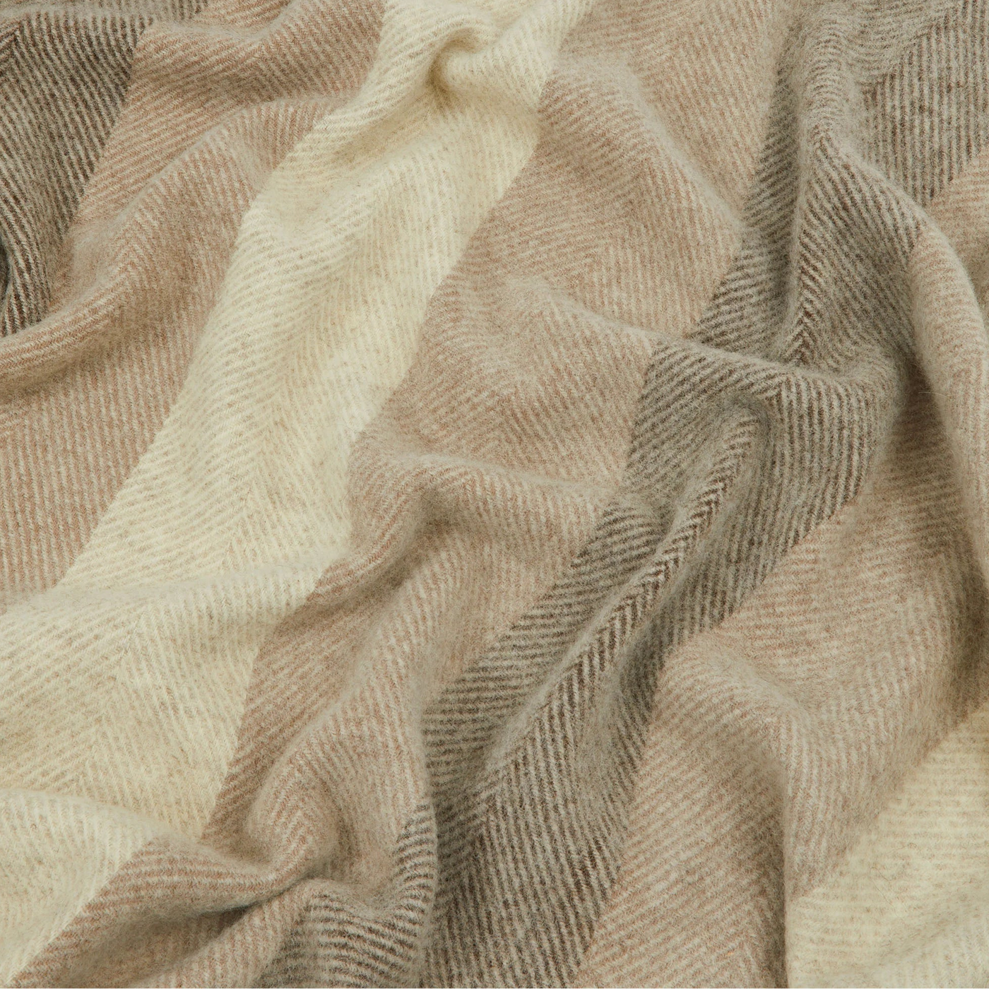 Close-up of Lanerossi Opua throw's herringbone weave in ivory and taupe tones.