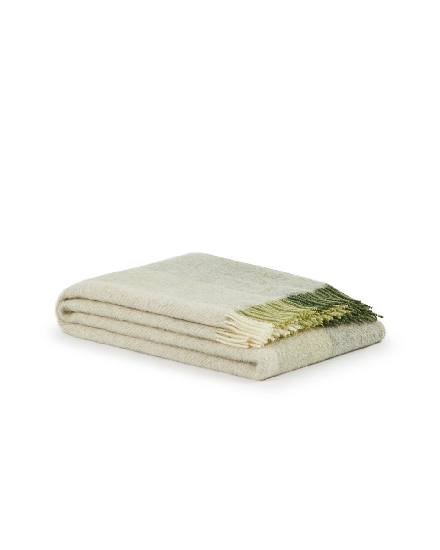 Close-up of folded Lanerossi Opua throw showing ivory and sage fringe detail.