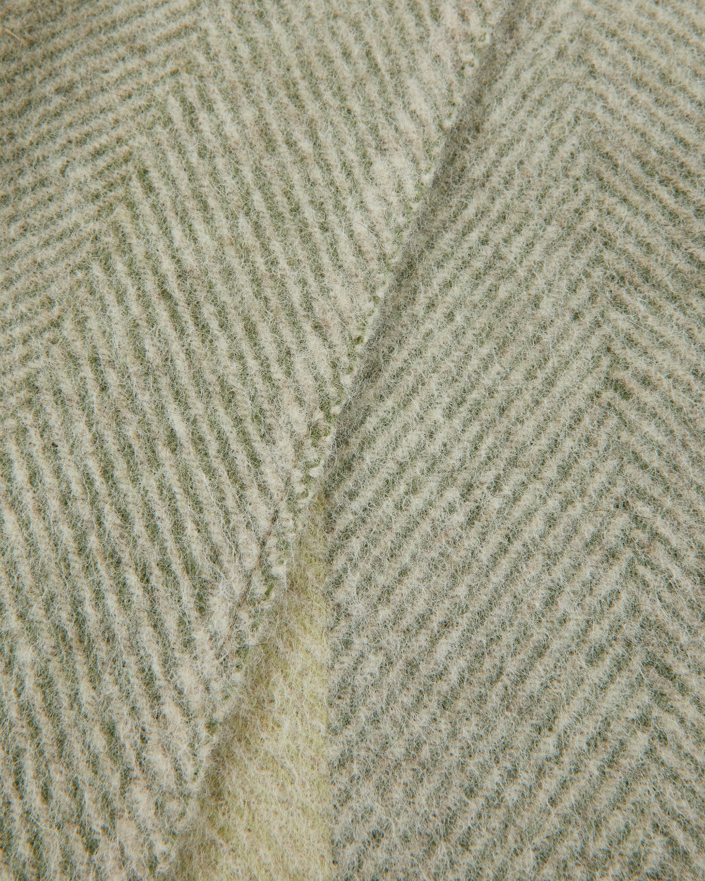 Close-up of sage and ivory herringbone weave on the Lanerossi Opua throw.