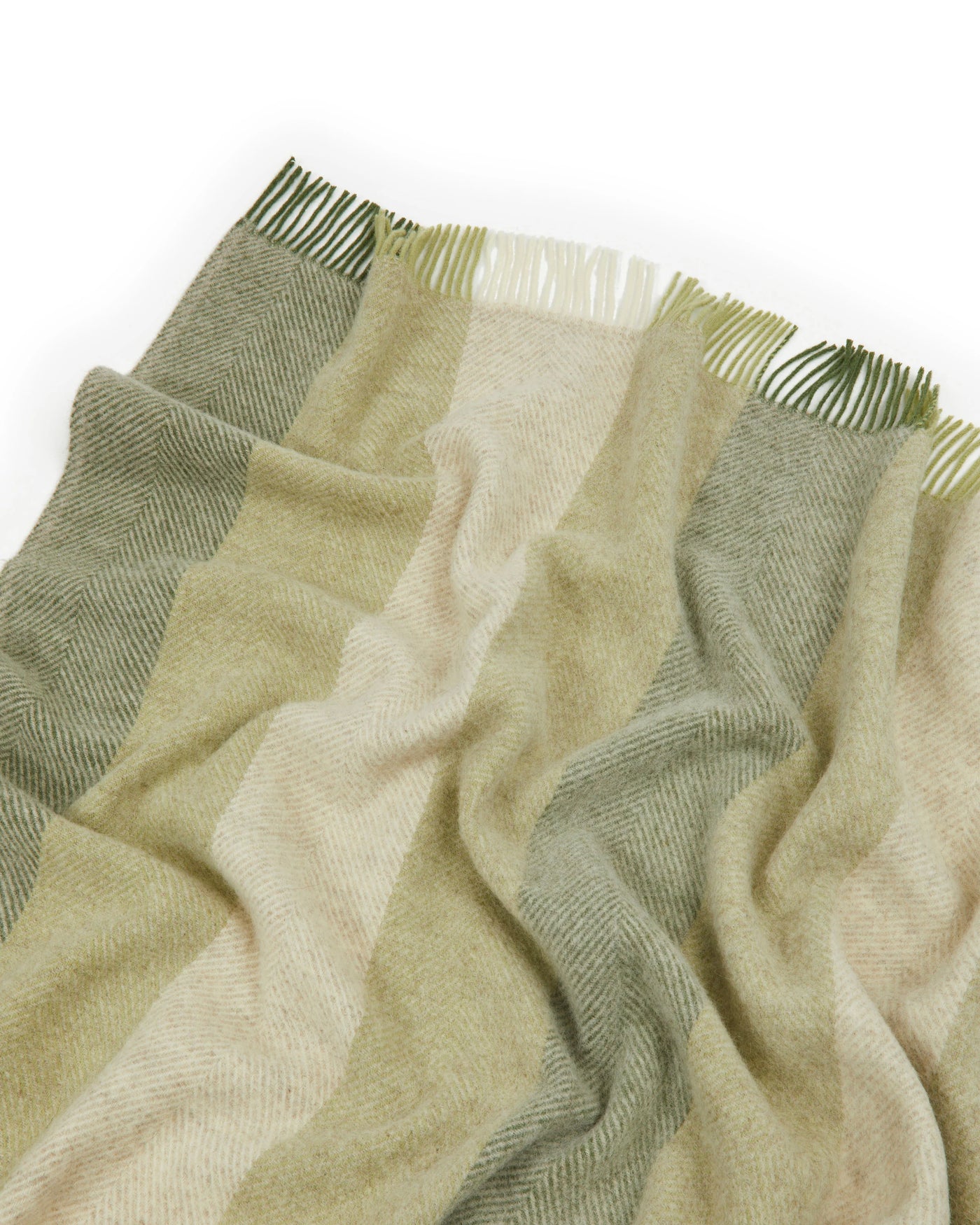 Close-up of Lanerossi Opua throw's fringed edge, sage and ivory herringbone stripe weave.
