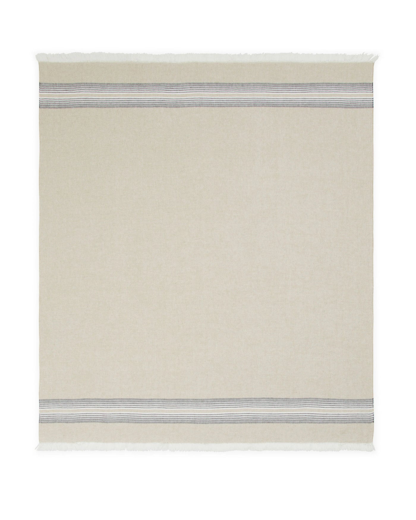 Close-up of Palau throw's blue-grey stripe border detail and fringe edge on ivory wool.