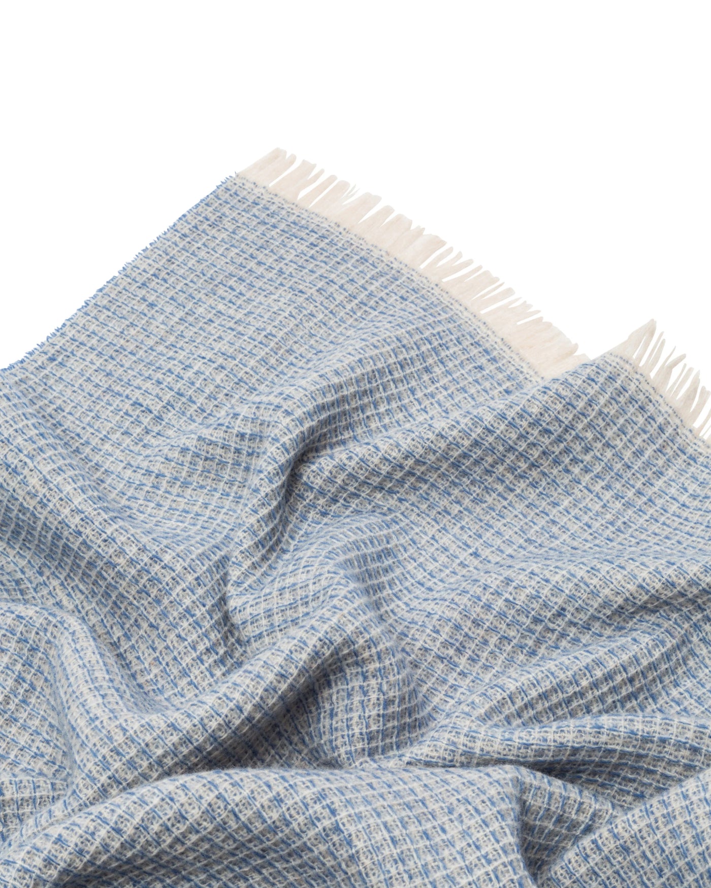 Close-up of Lanerossi Rossi Moon throw in blue, showing woven texture and ivory fringe trim.