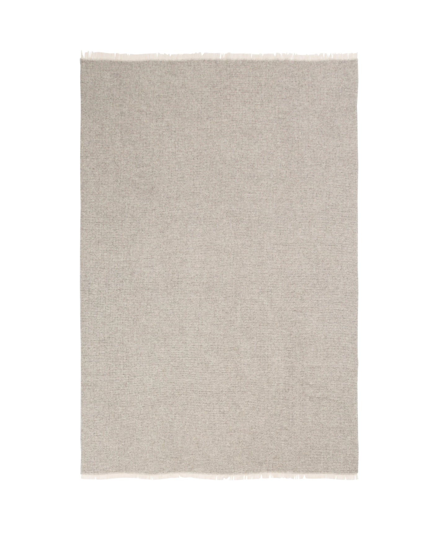 Flat lay of a greige wool throw with fringe trim along the short edges.