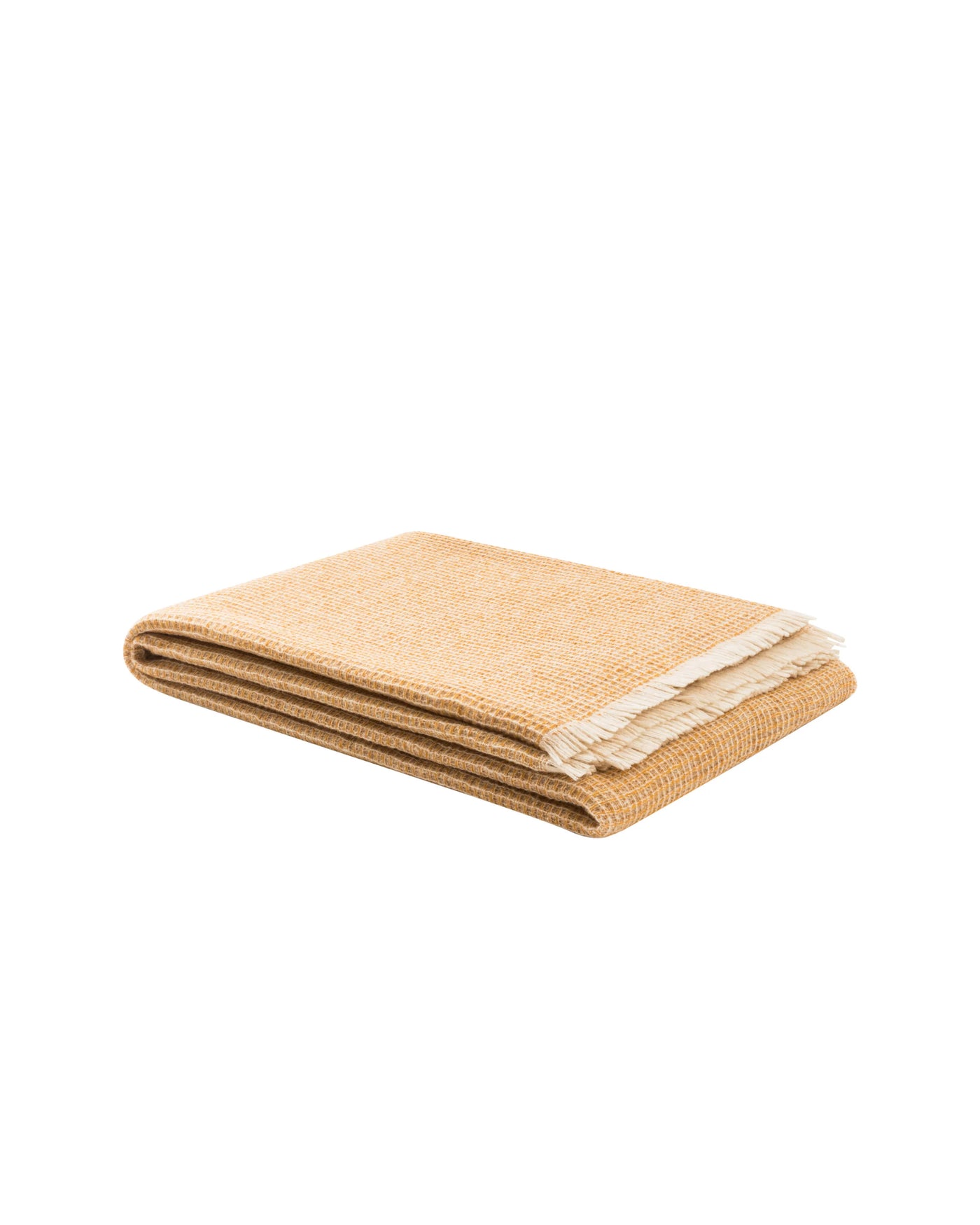 Folded amber throw with ivory fringe trim, showing textured herringbone weave.