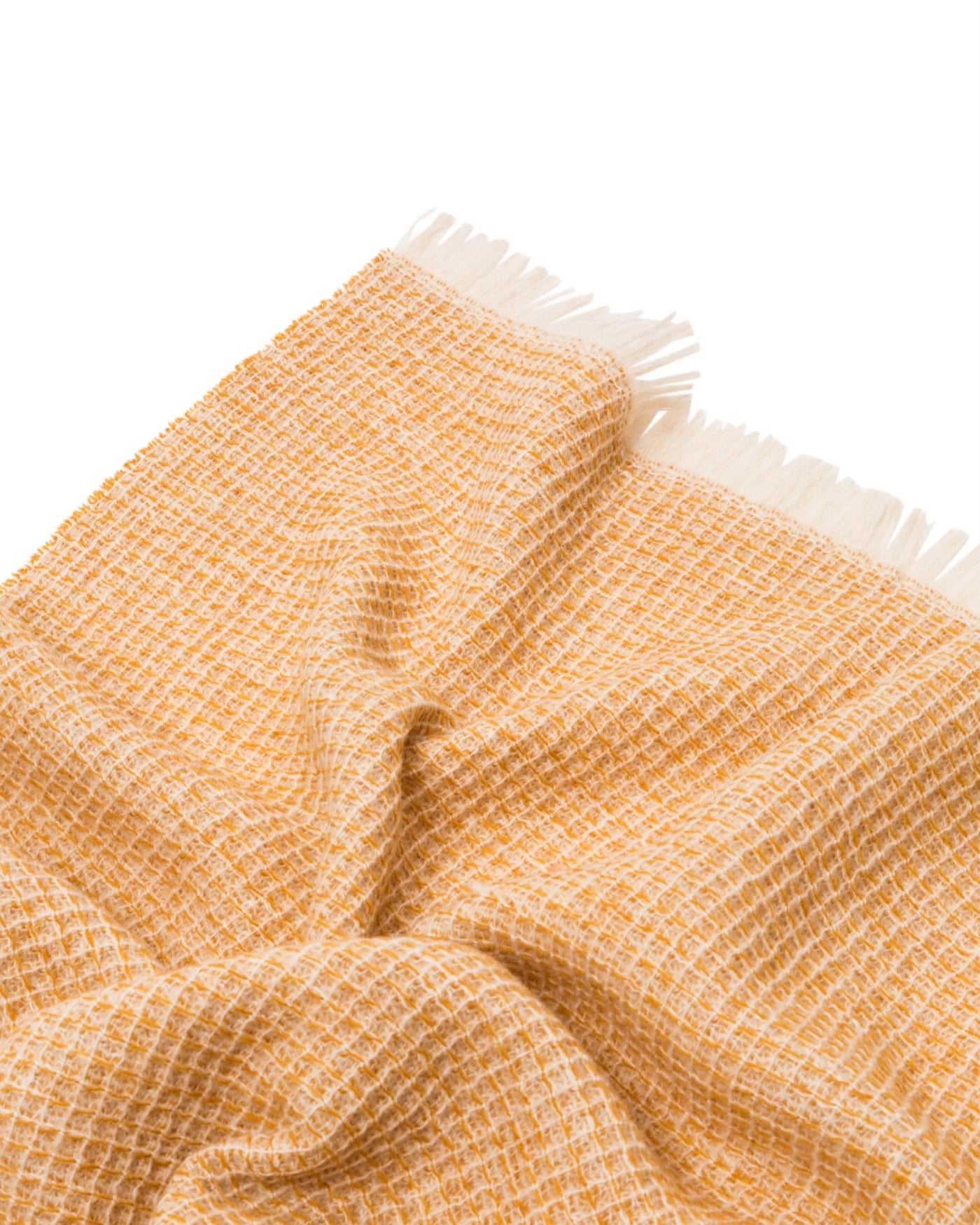 Close-up of Lanerossi Rossi Moon throw in amber and ivory woven texture with fringe trim.