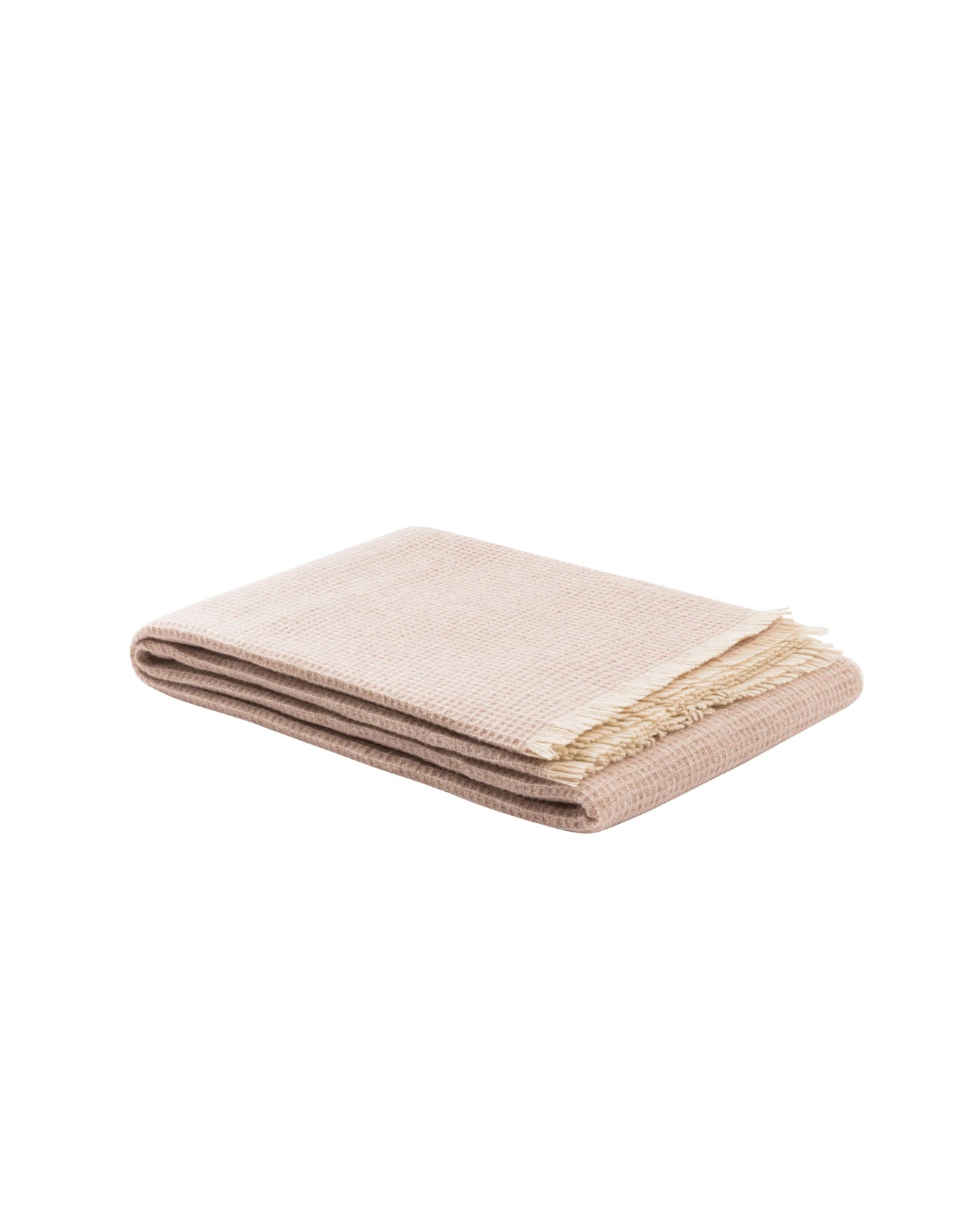 Folded blush throw with ivory fringe trim, showing ribbed weave texture.