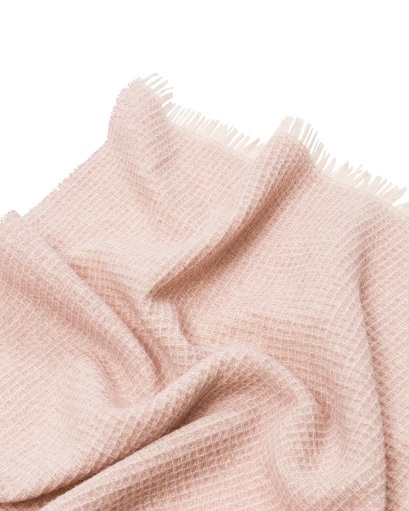 Close-up of Lanerossi Rossi Moon throw in blush, showing open waffle weave and fringe edge.