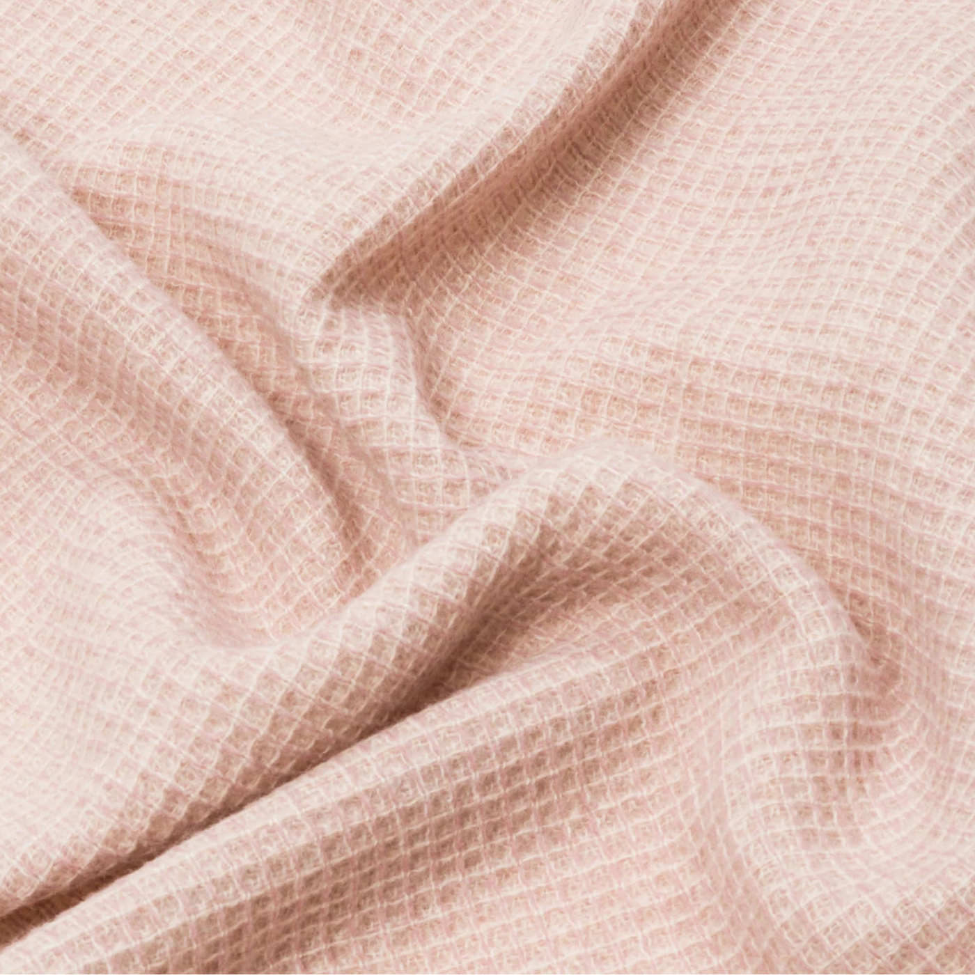 Close-up of Lanerossi Rossi Moon throw in blush, showing draped waffle-weave texture.