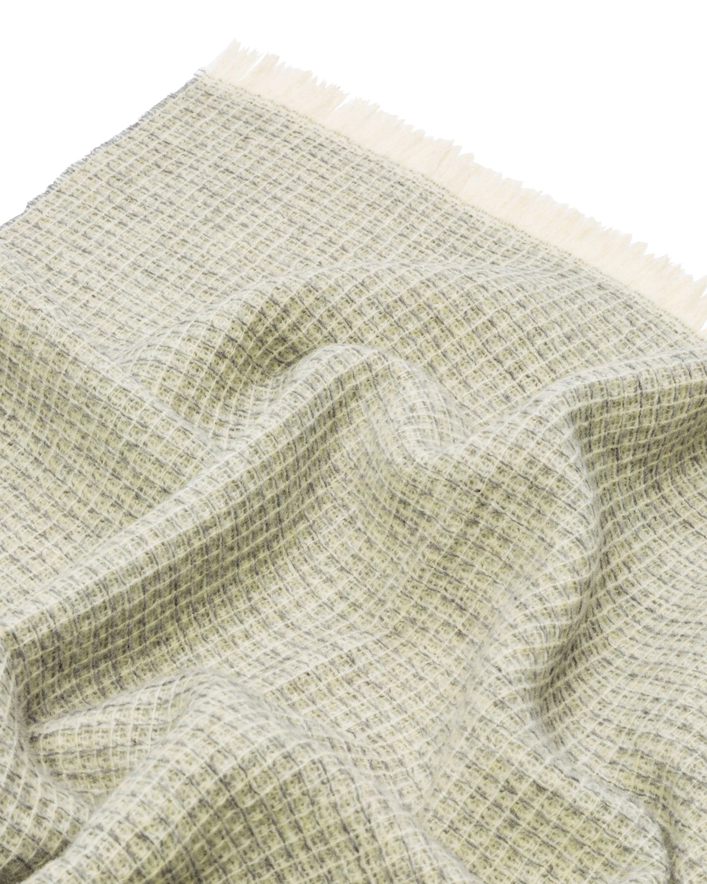 Close-up of Lanerossi Rossi Moon throw in sage, showing waffle weave texture and ivory fringe edge.