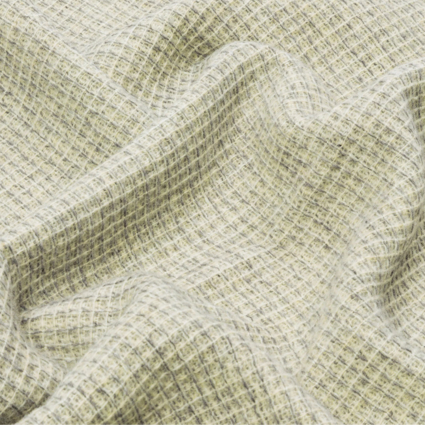 Close-up of draped Lanerossi Rossi Moon throw showing sage green open-weave texture.