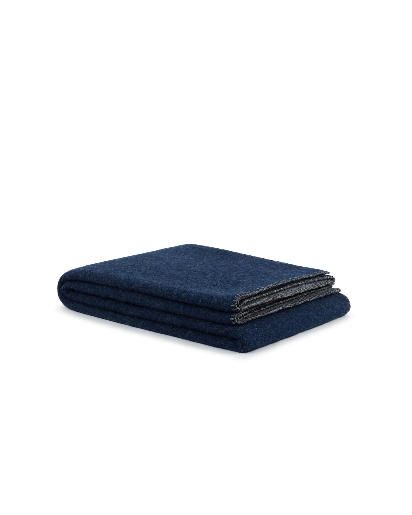 Close-up of folded Lanerossi Southland throw in navy with charcoal edge binding detail.