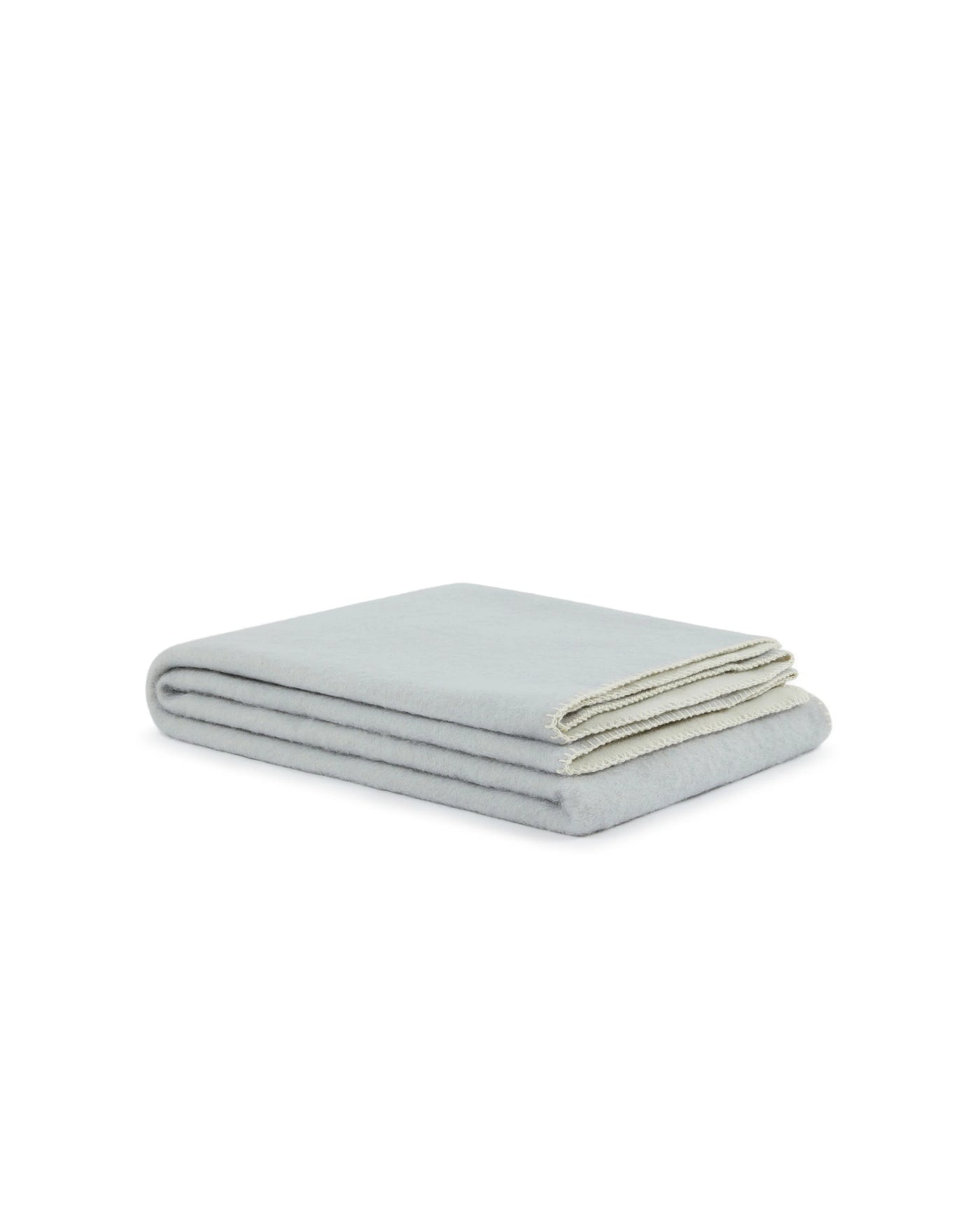 Lanerossi Southland throw folded flat, pale aqua brushed wool with ivory contrast edge.