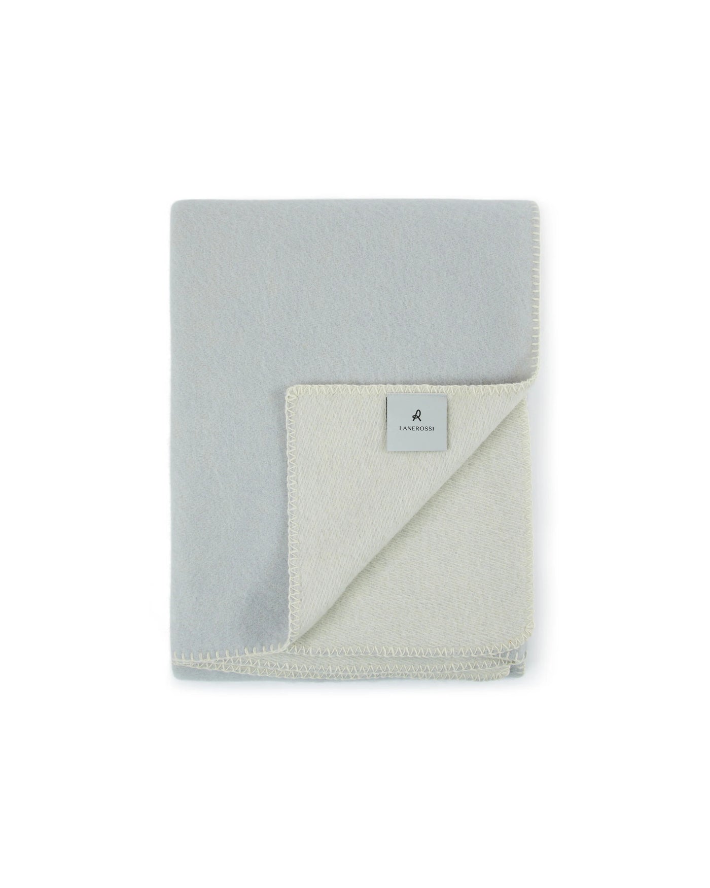 Folded Lanerossi Southland throw in mist blue, ivory reverse visible with branded label.