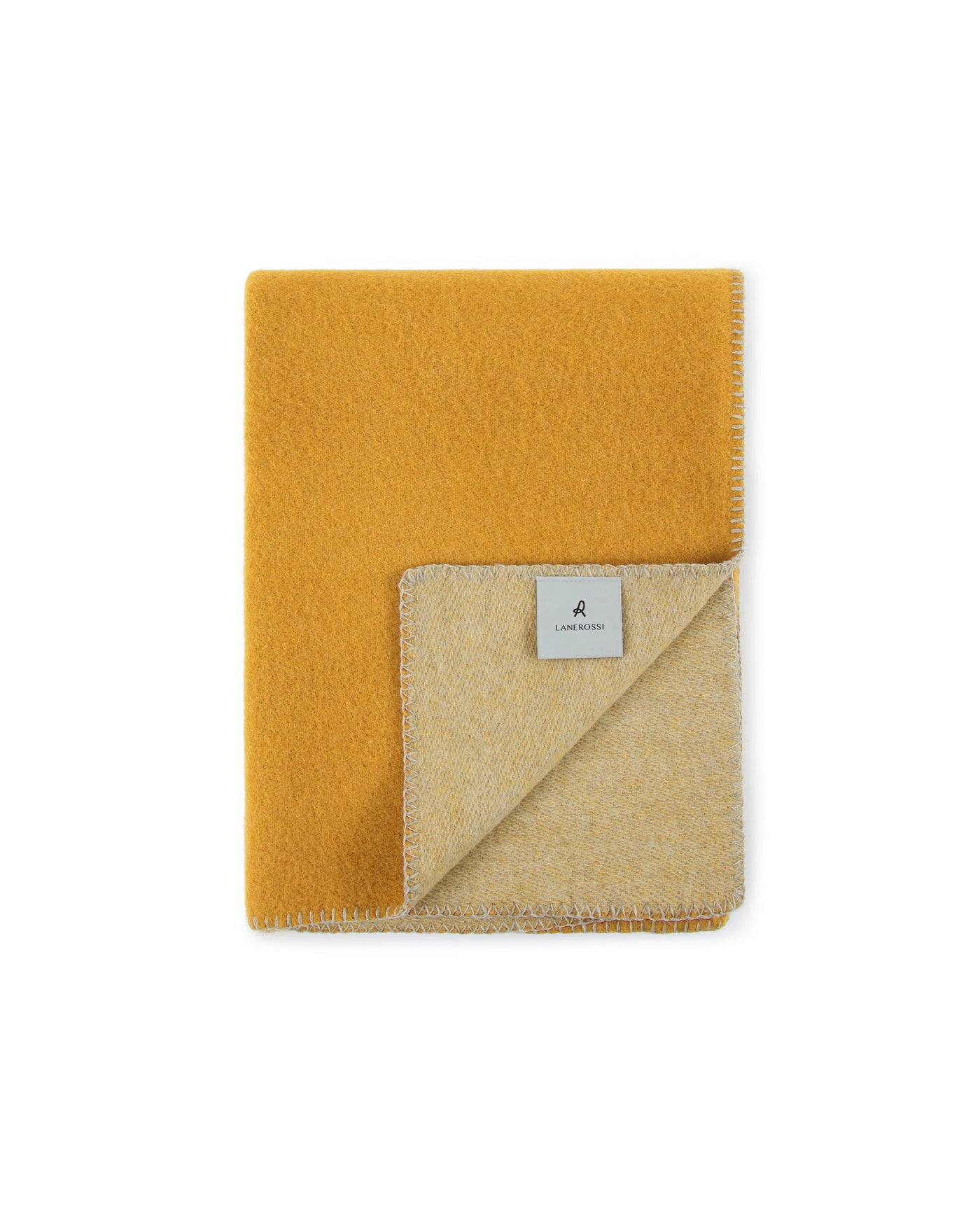 Reversible saffron and oat wool throw folded to show both colorways, with whipstitch edges.
