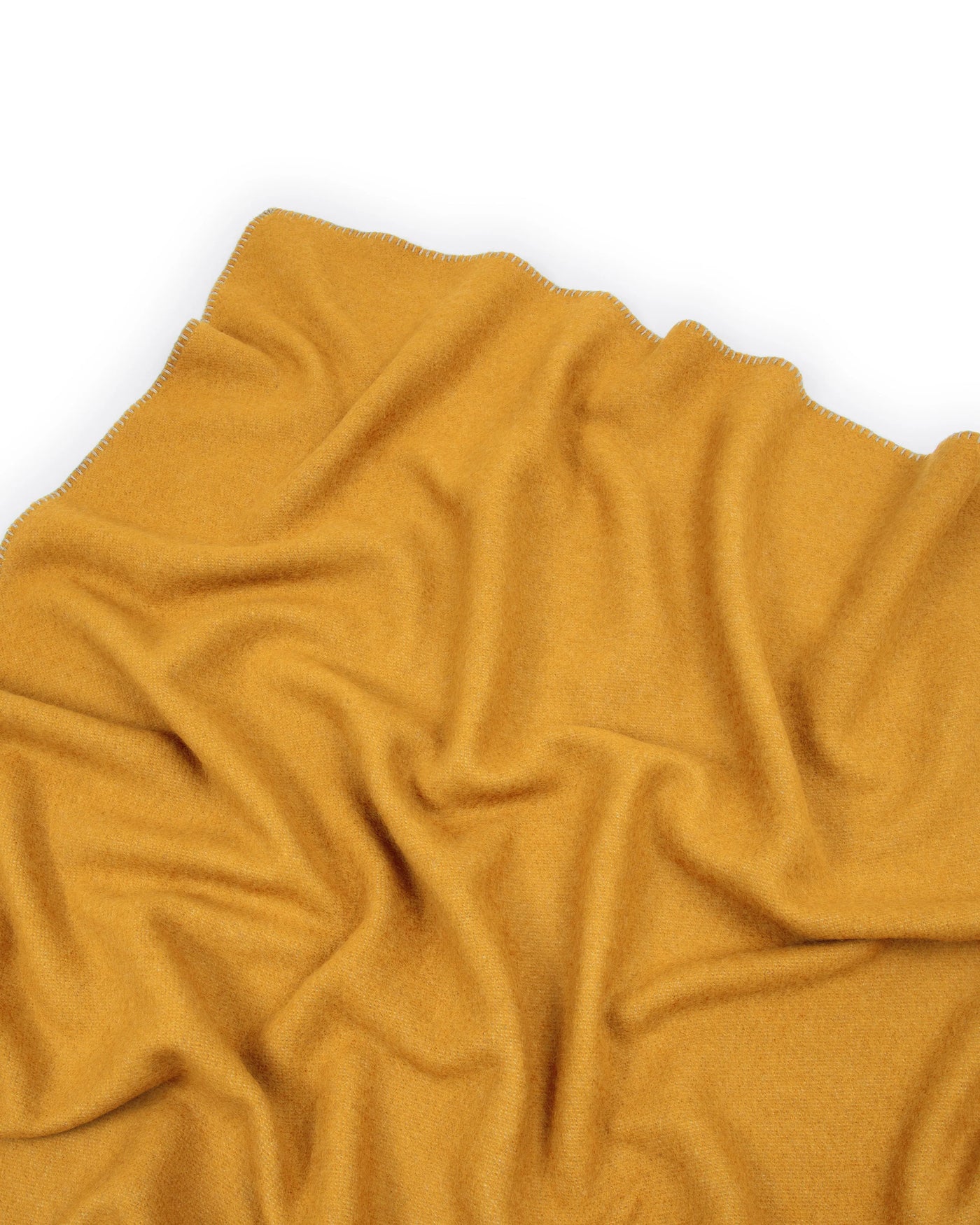 Close-up of Lanerossi Southland throw in saffron, showing soft draped wool texture.