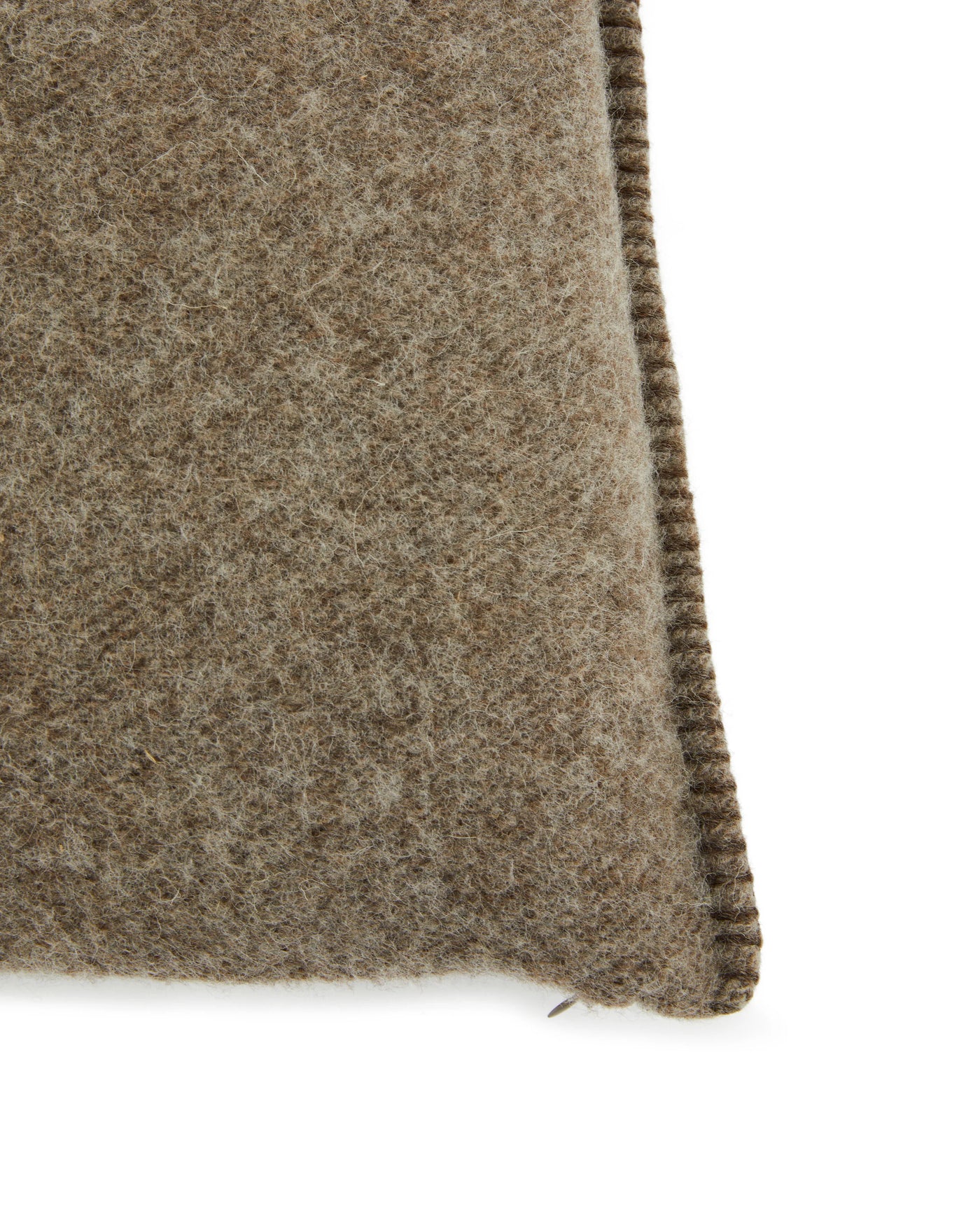 Close-up of Lanerossi Southland cushion corner, showing taupe wool texture and whipstitch edge detail.