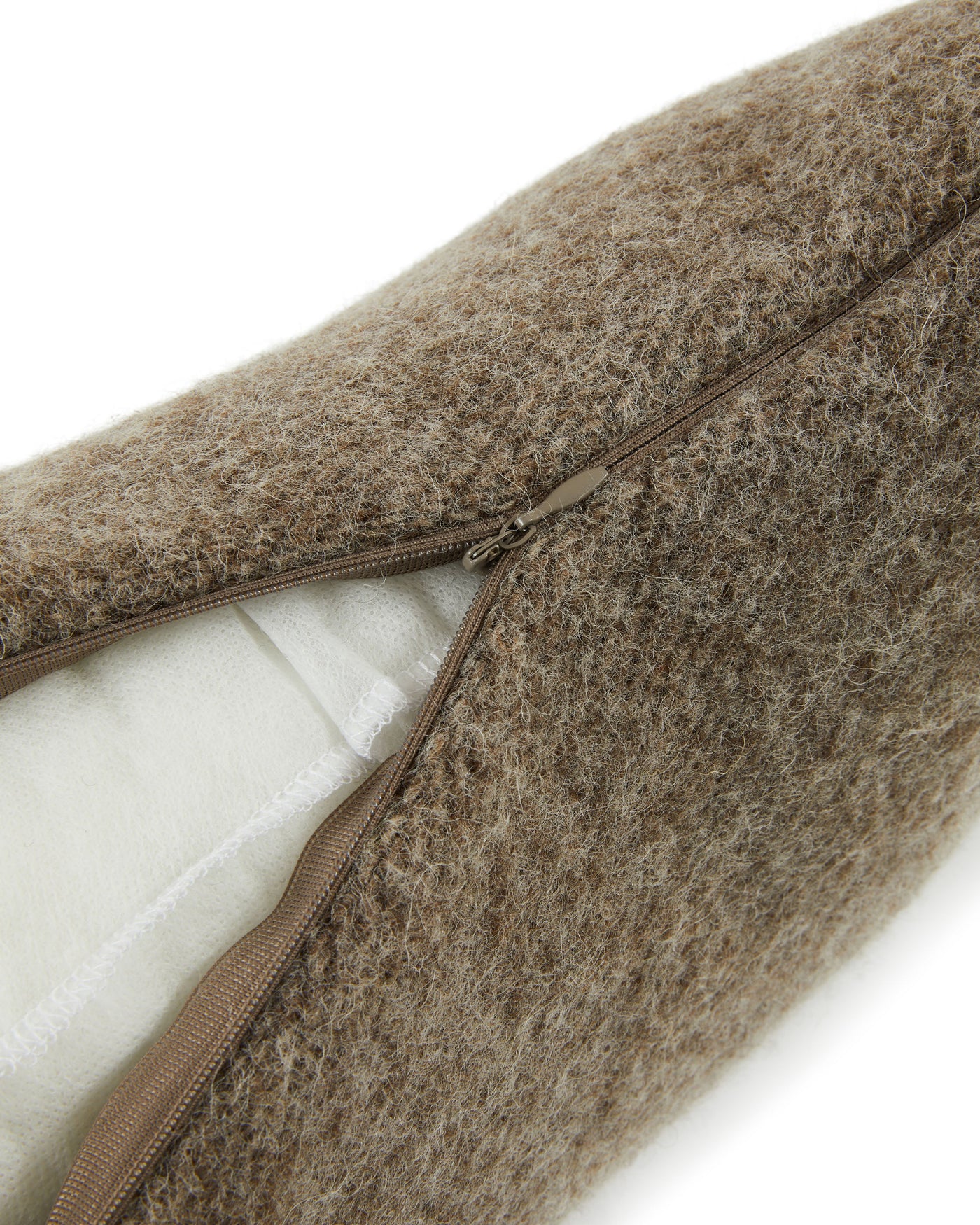 Close-up of taupe brushed wool cushion zipper closure, ivory lining visible.