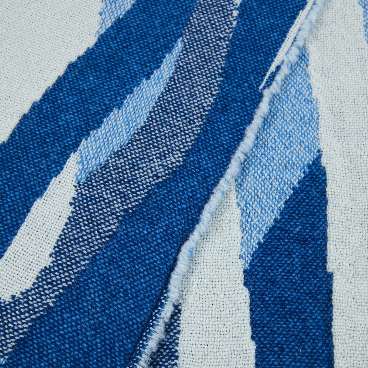 Close-up of Lanerossi Struttura throw weave, navy and sky blue diagonal stripe detail.