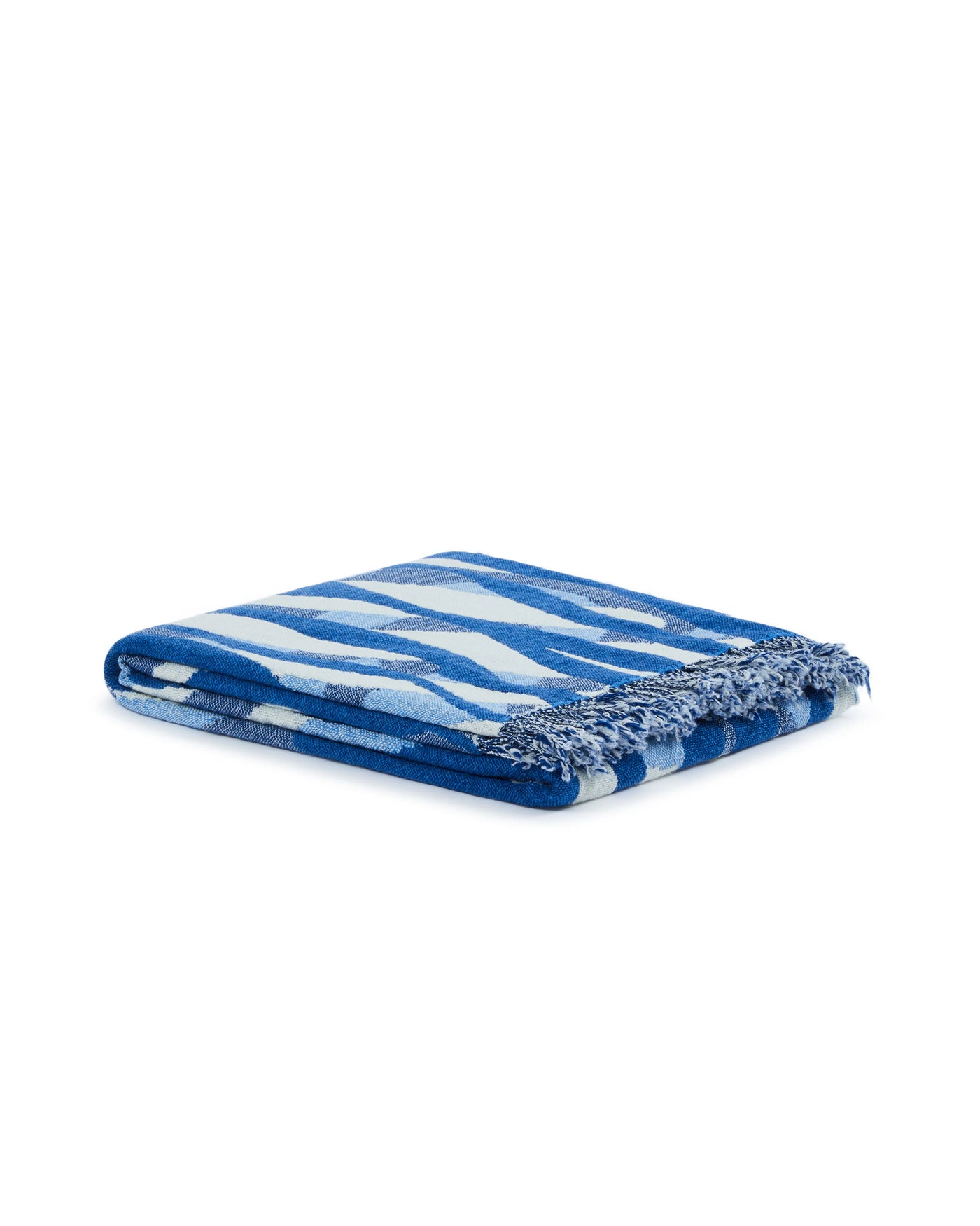Lanerossi Struttura throw folded, cobalt blue abstract stripe pattern with fringe trim.