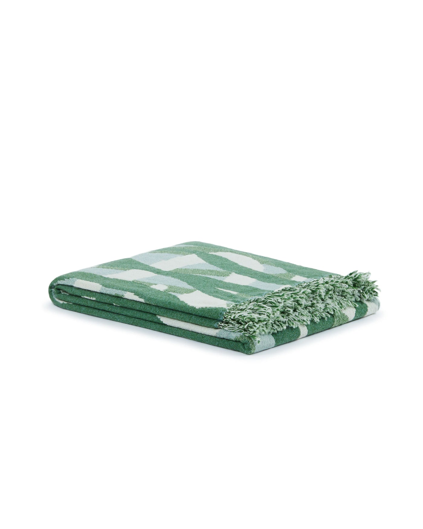 Lanerossi Struttura throw folded, green abstract pattern with fringe trim.