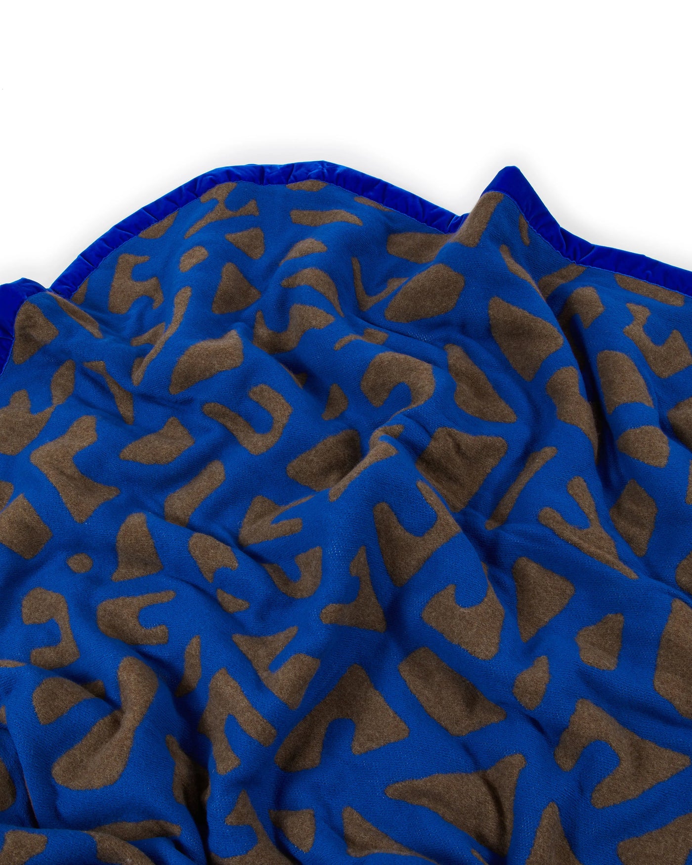 Lanerossi Tribal blanket draped, showing cobalt blue and taupe abstract pattern with contrast trim.