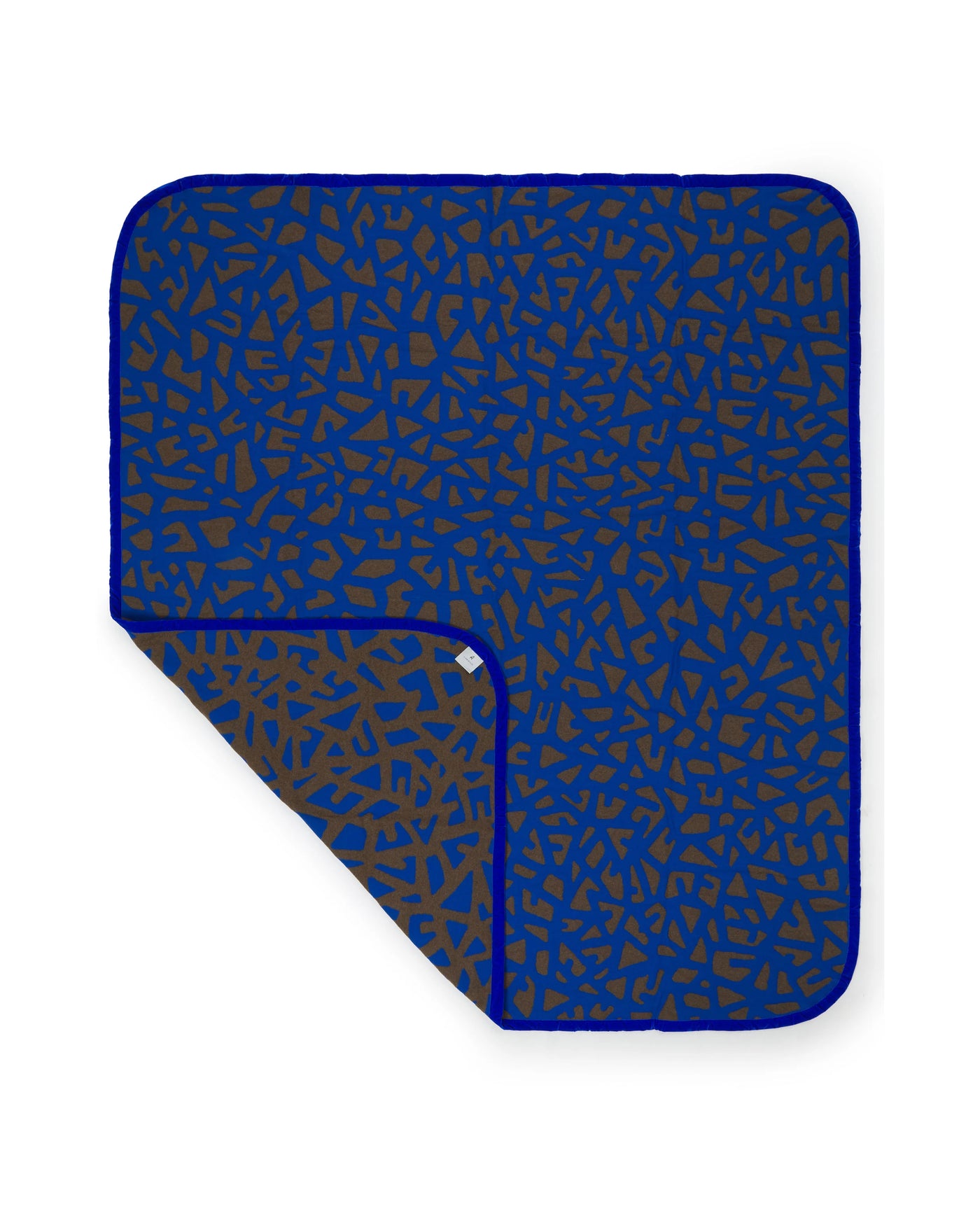 Lanerossi Tribal blanket corner folded back, showing cobalt and brown terrazzo reverse.