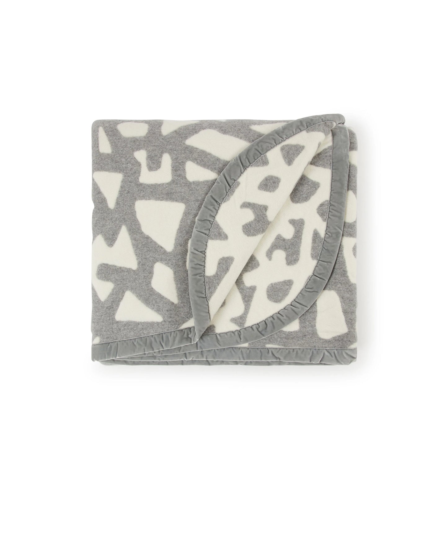 Folded Lanerossi Tribal blanket showing grey abstract pattern and ruffled border detail.