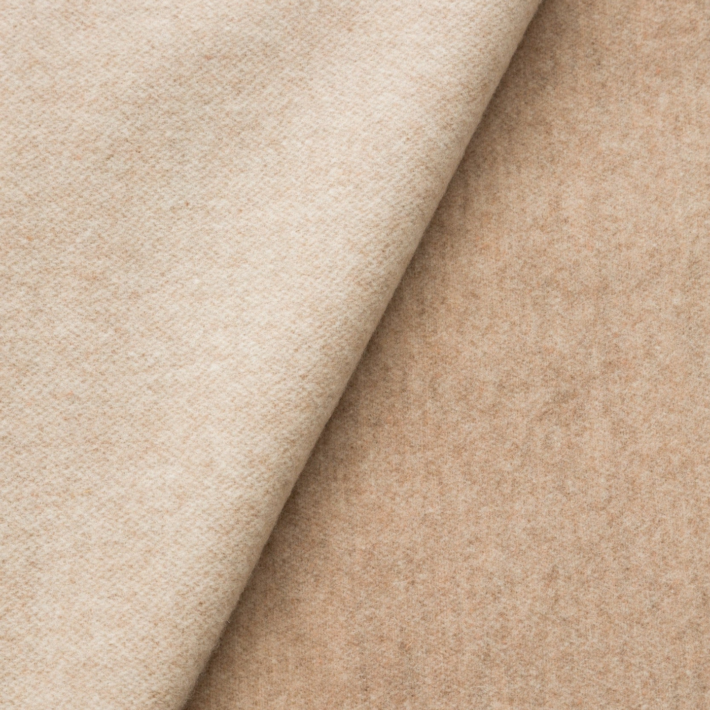 Close-up of Lanerossi Ulisse throw in sand, showing soft wool fabric fold and texture.