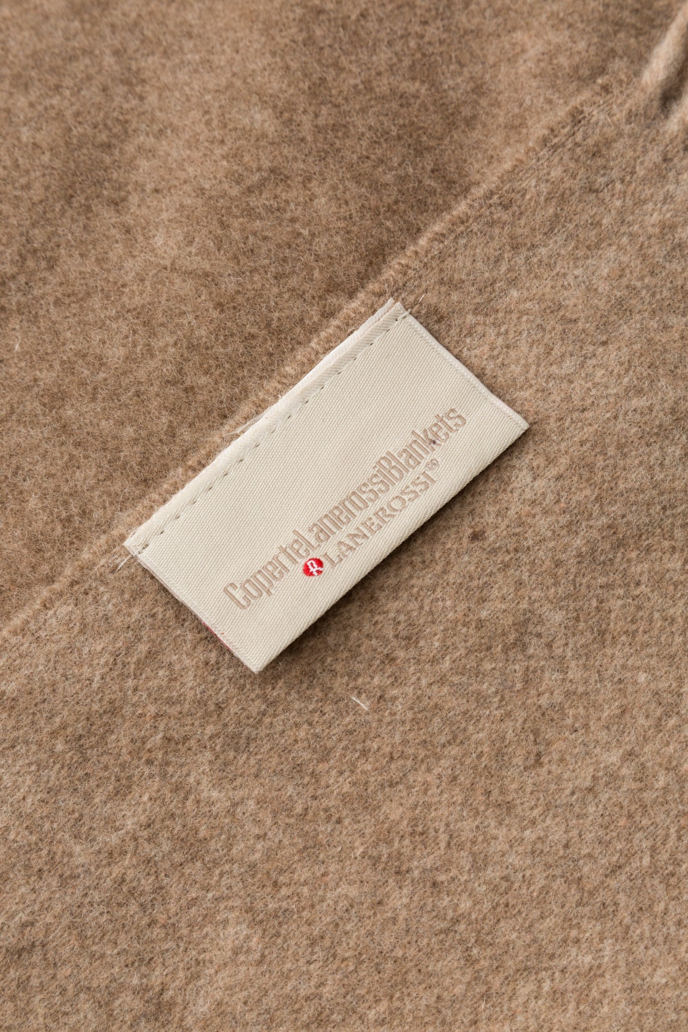 Close-up of Lanerossi label on taupe wool Ulisse throw.