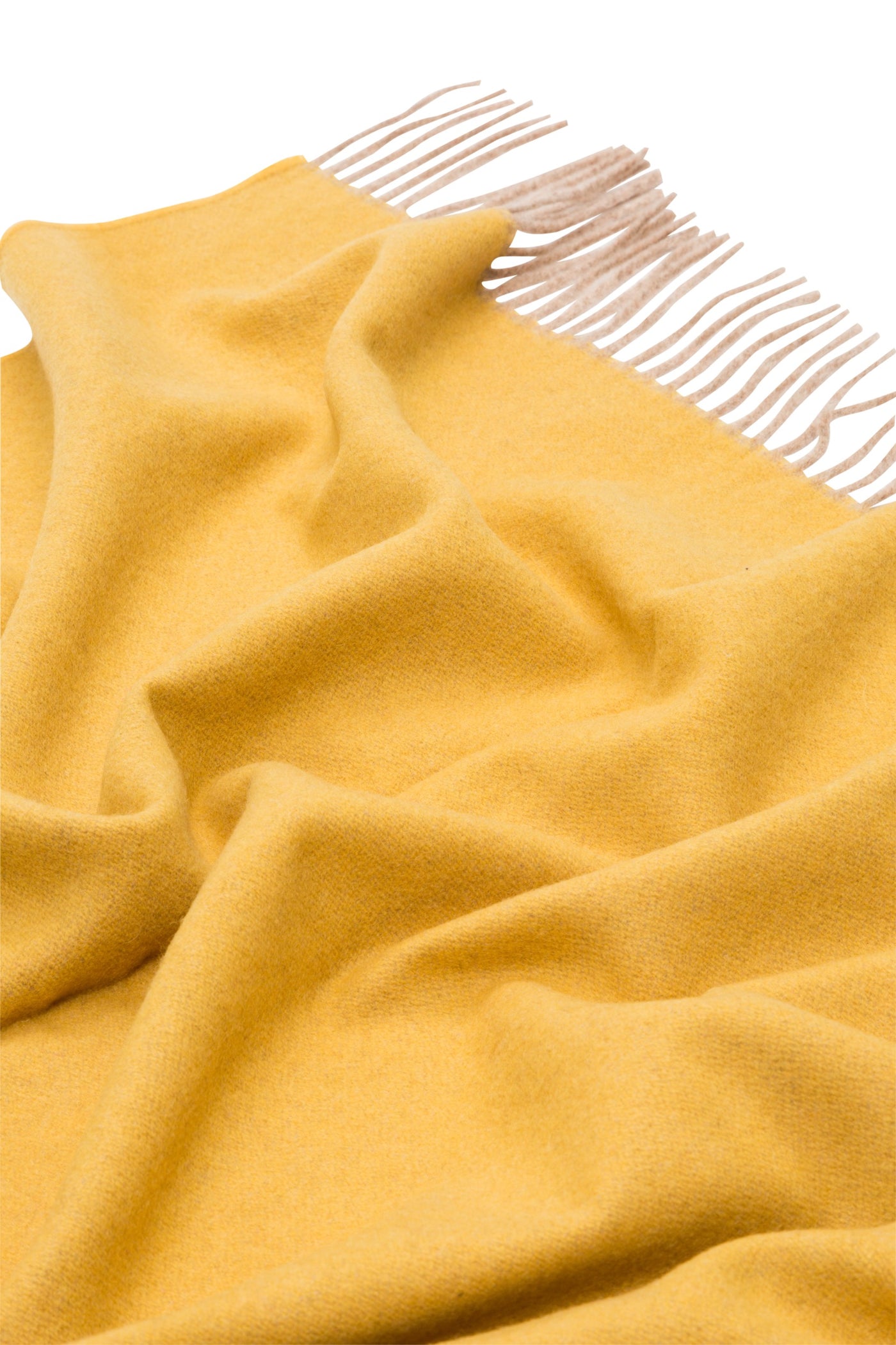 Close-up of saffron Lanerossi Ulisse throw with ivory fringe detail and soft draping.