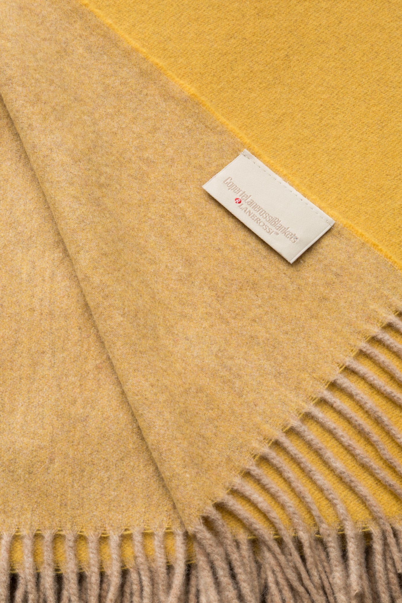 Close-up of Lanerossi Ulisse throw in golden yellow, showing reversible face and fringe detail.