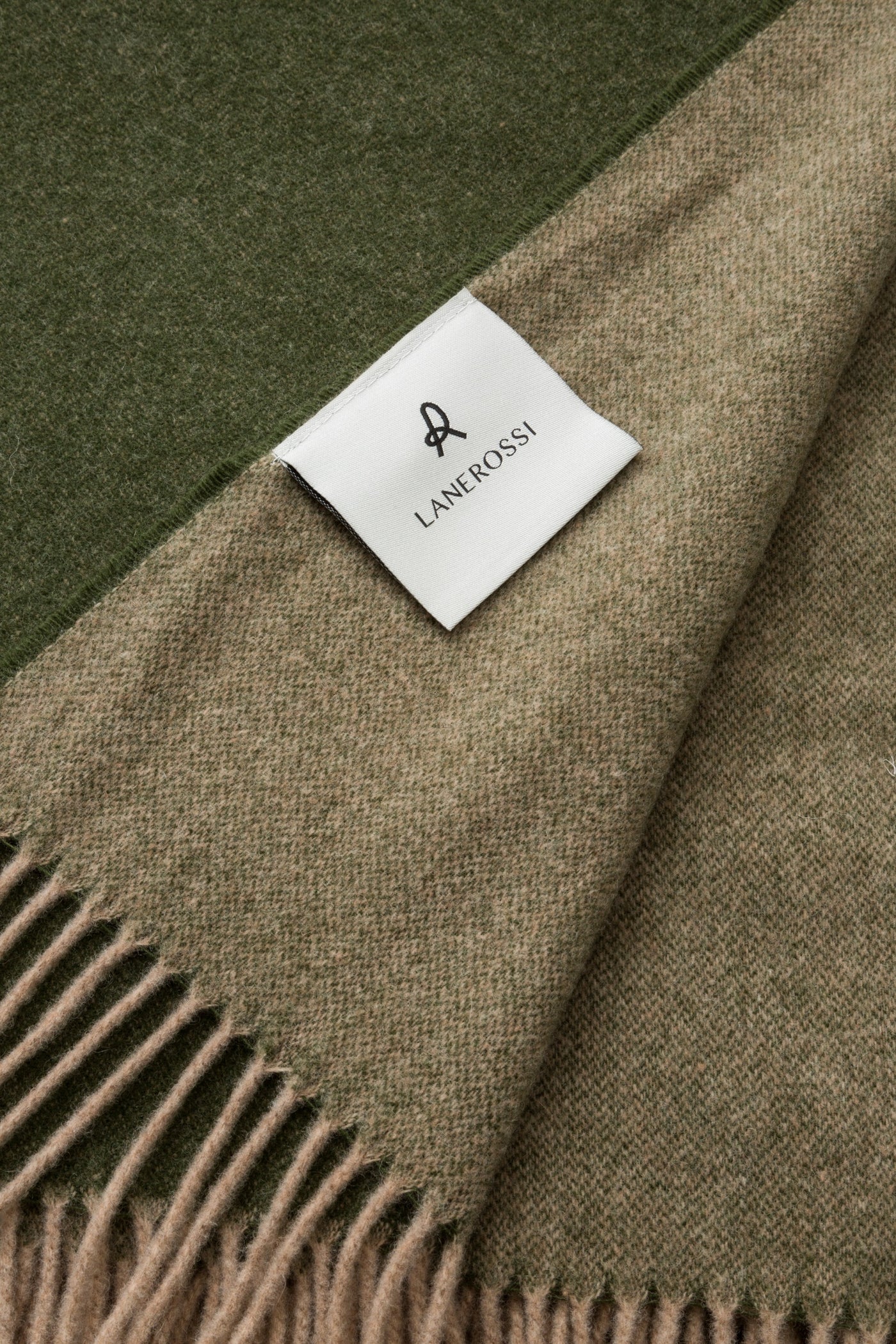Lanerossi Ulisse throw in forest green and taupe wool with fringe trim and woven label.