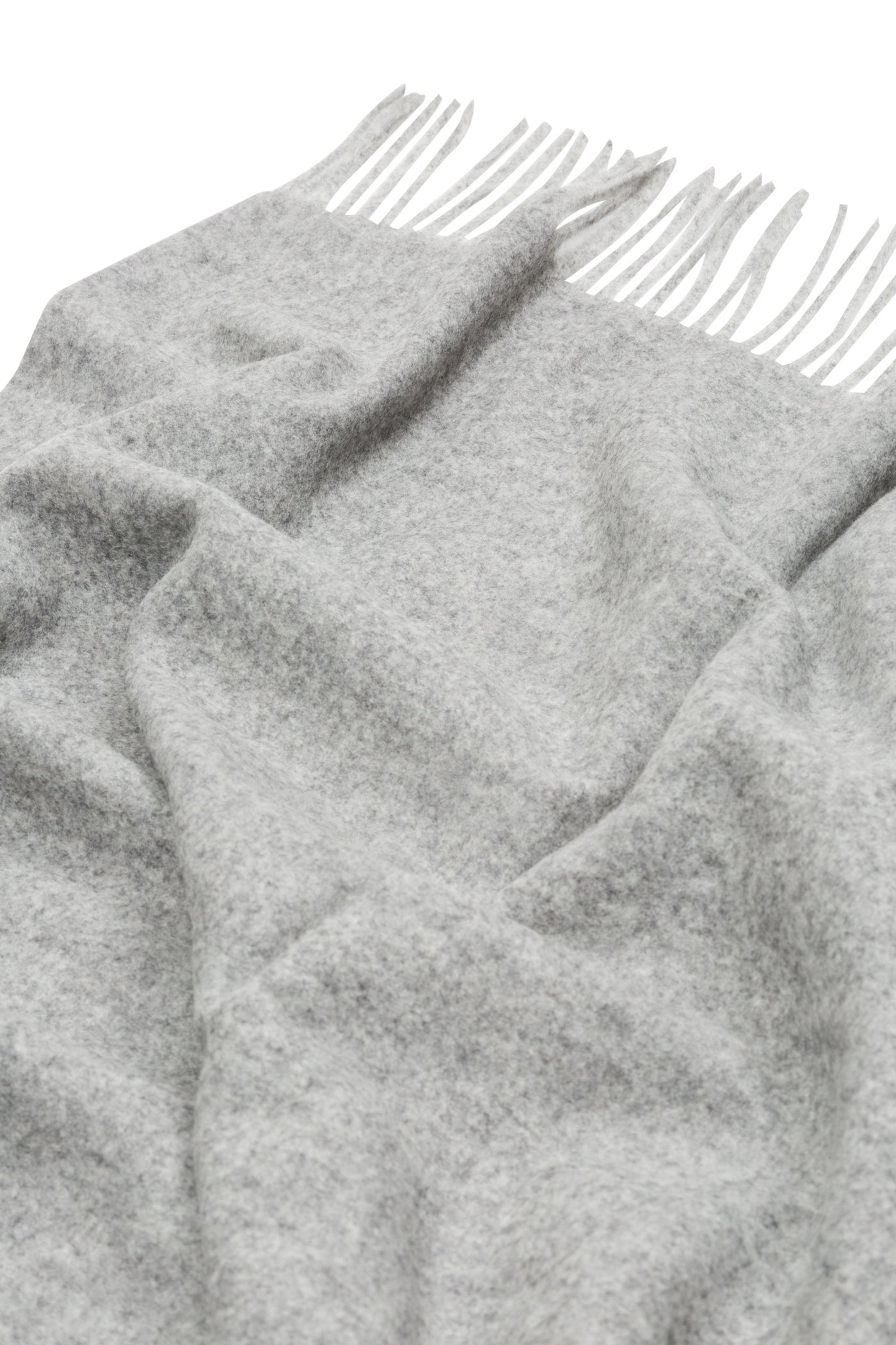 Draped silver grey wool throw with knotted fringe trim, showing soft brushed texture.